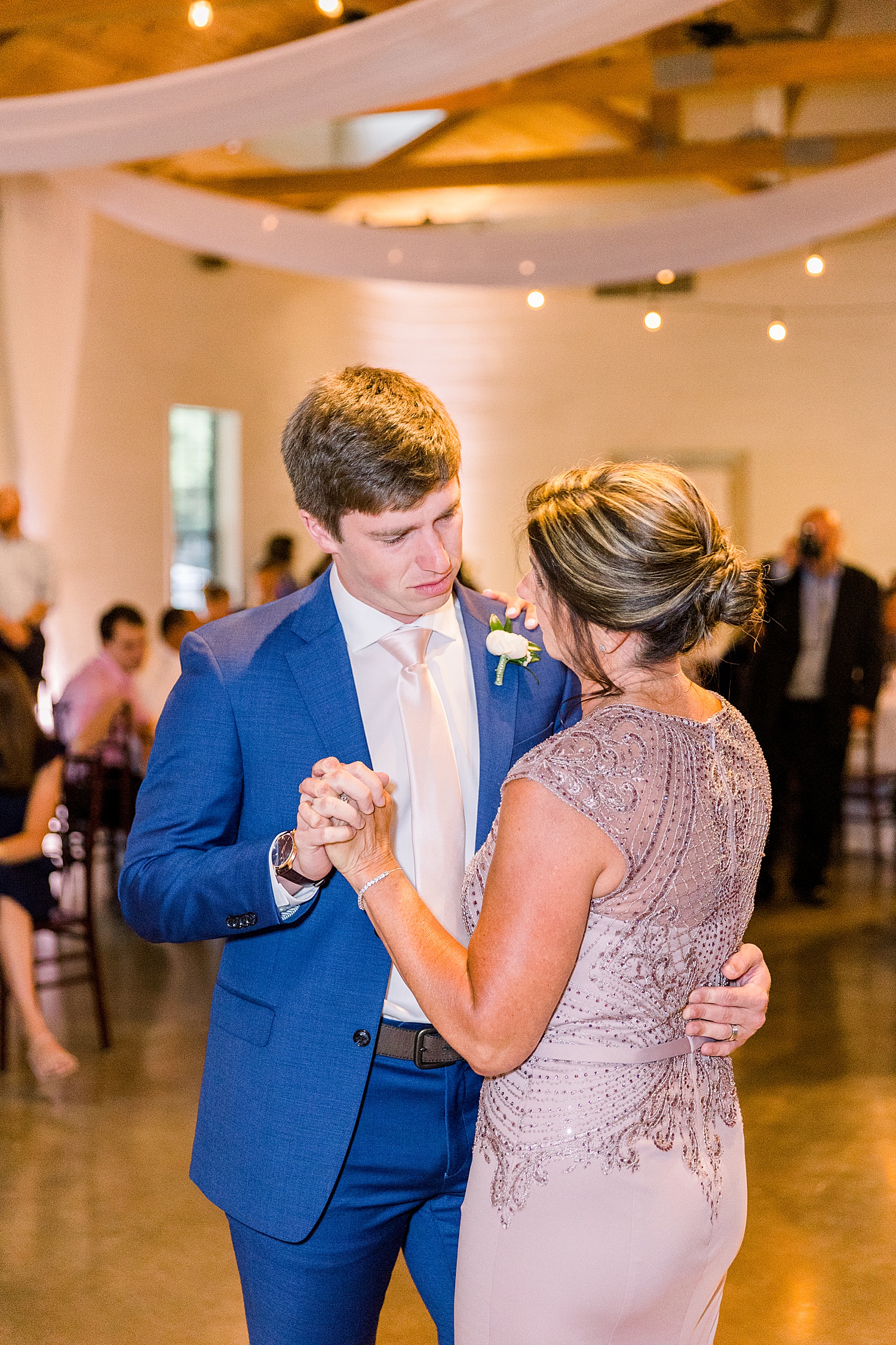 Groom and mother dance together during mother-son dance at AL wedding reception