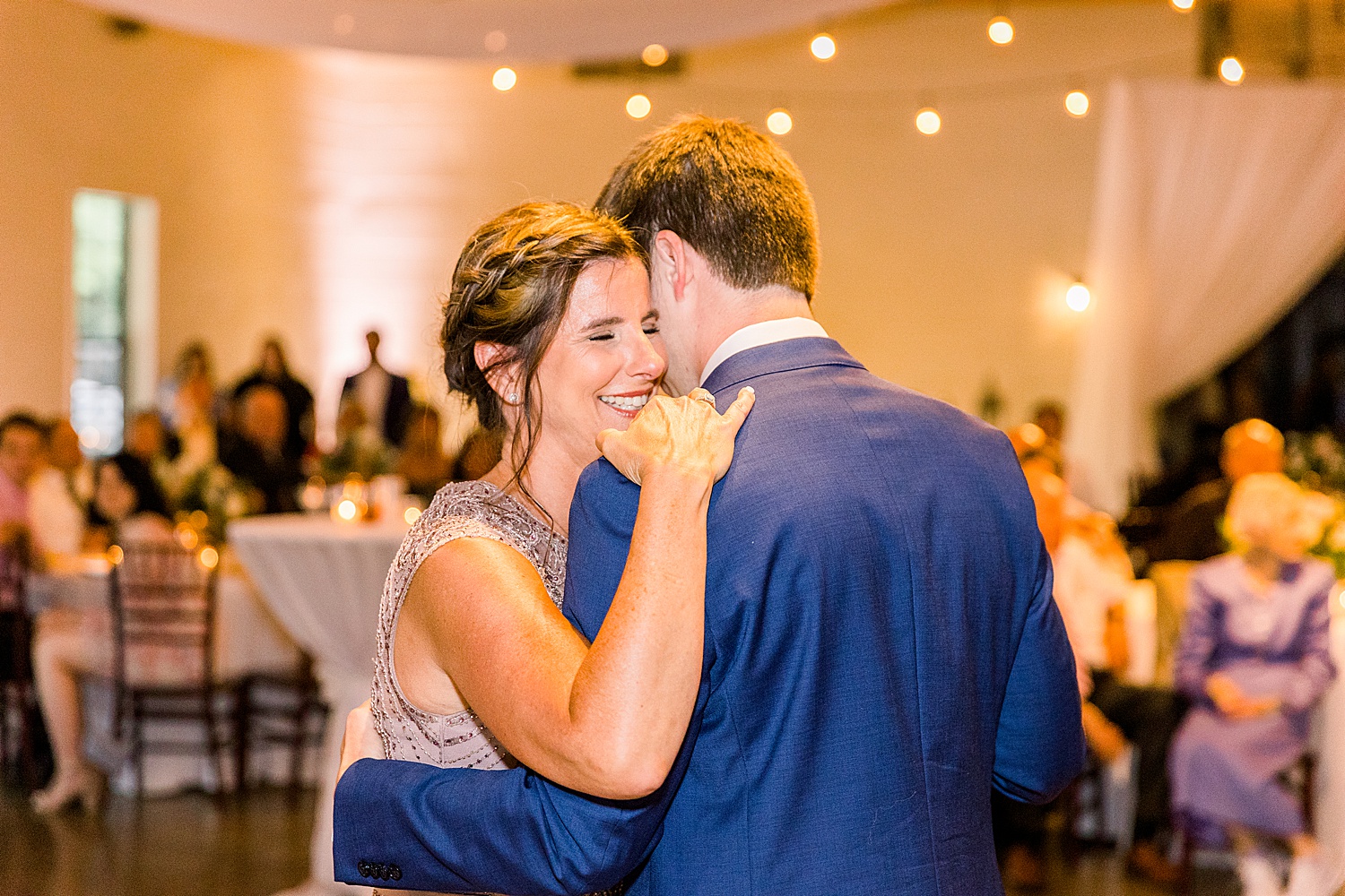 Groom and mother dance together during mother-son dance at AL wedding reception