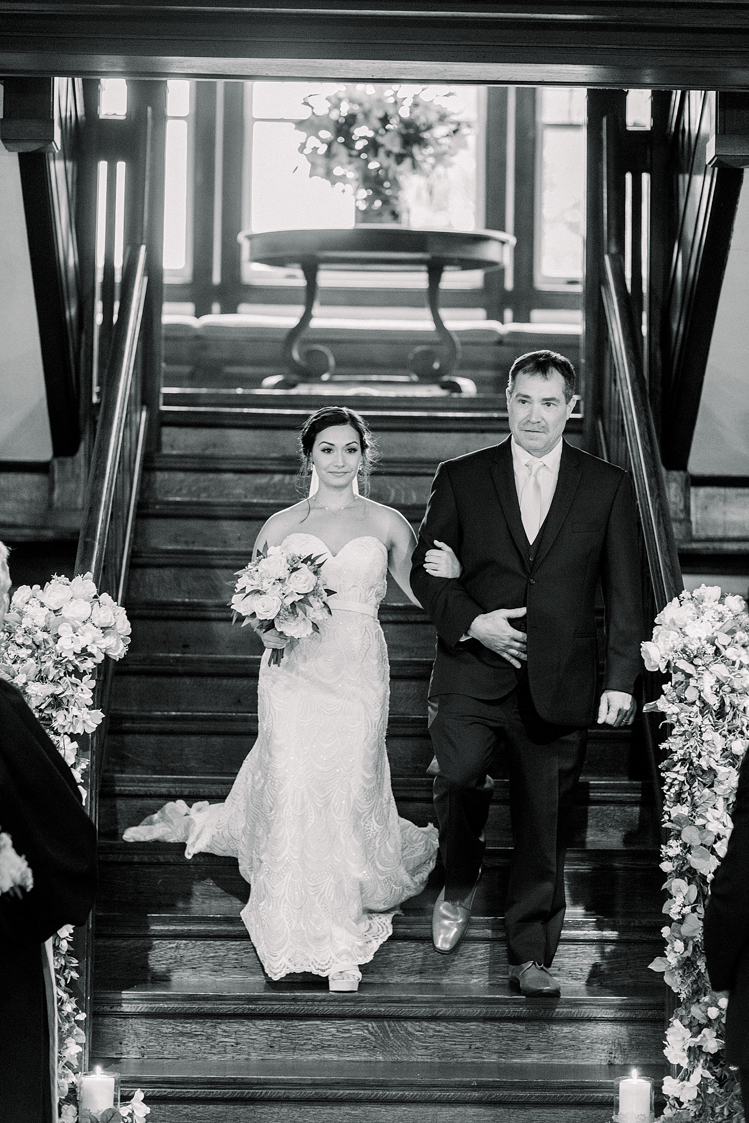 father of the bride walks daughter down stairs