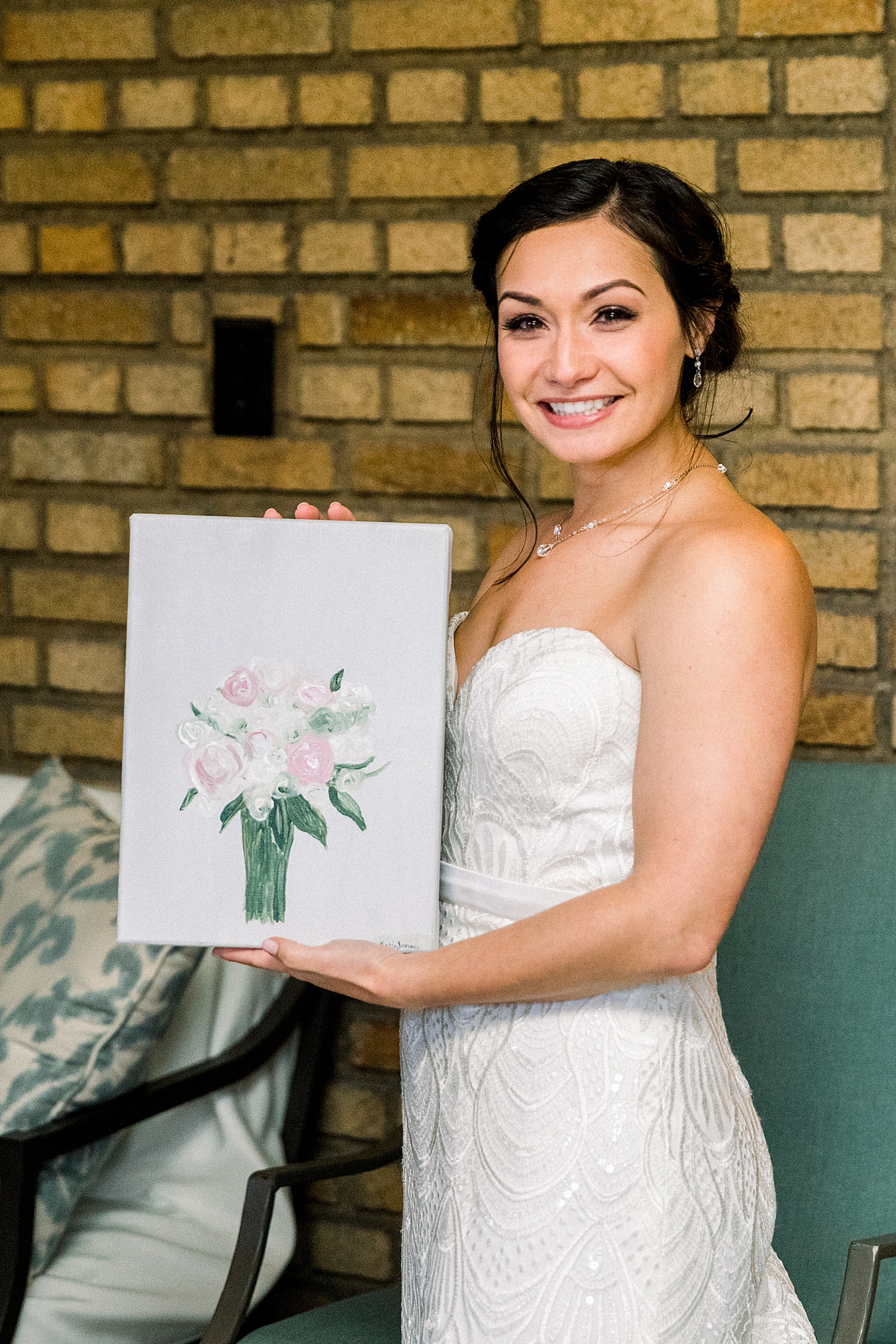 bride with painting of wedding bouquet