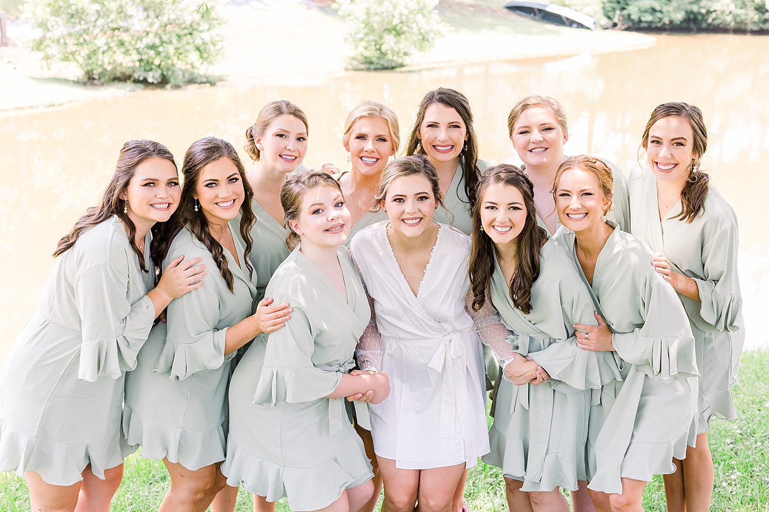 Bride + Bridesmaids in matching Sage green robes before Summer Belle Farm Wedding