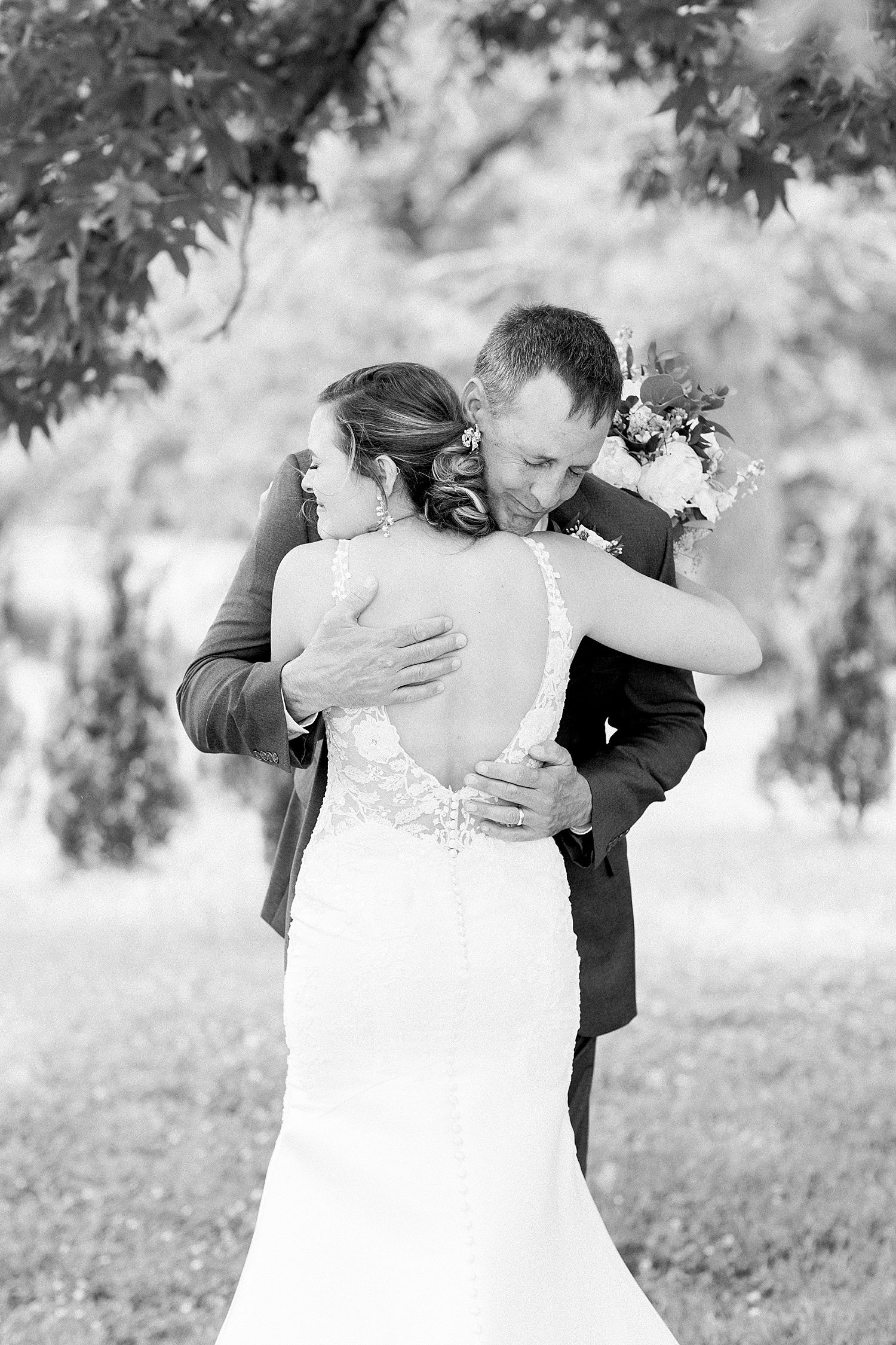 Bride + dad hug during First Look at Belle Farms Summer Wedding in Alabama