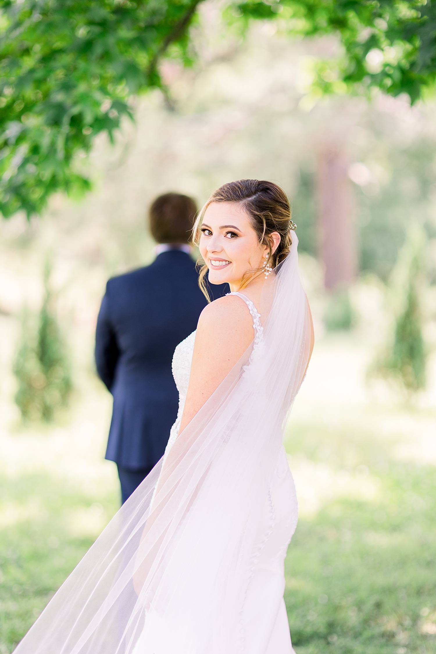 Bride waiting for groom to turn around during first look by Chelsea Morton Photography