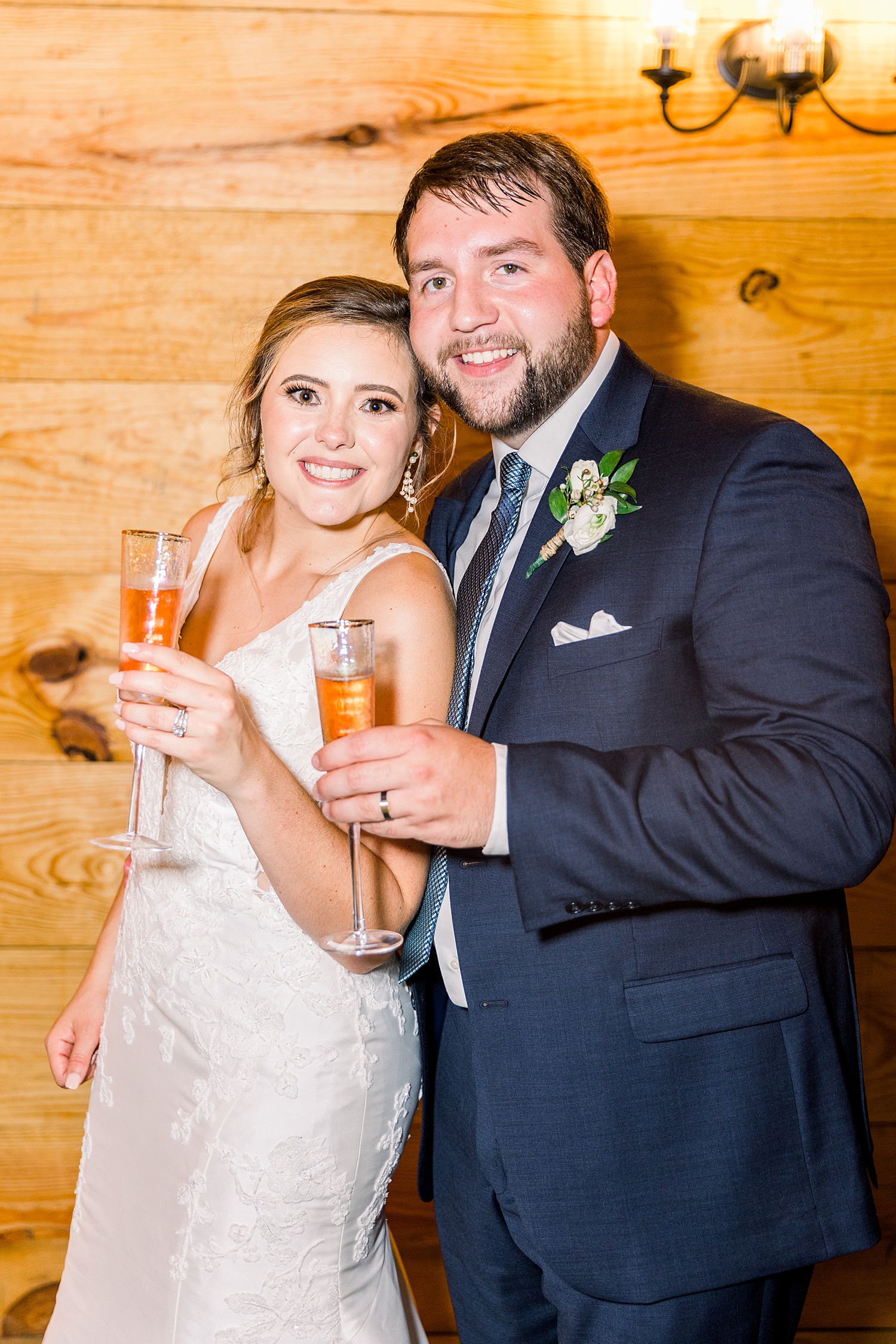 newlyweds toast with champagne at Belle Farms wedding reception in Alabama