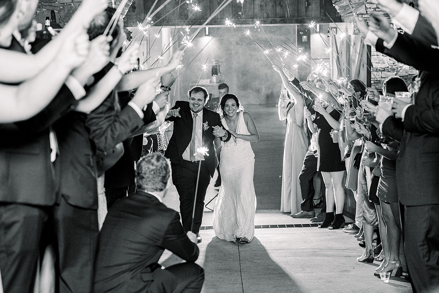 Guests hold sparklers to celebrate newlyweds at the end of wedding night at Park Crest Events in AL