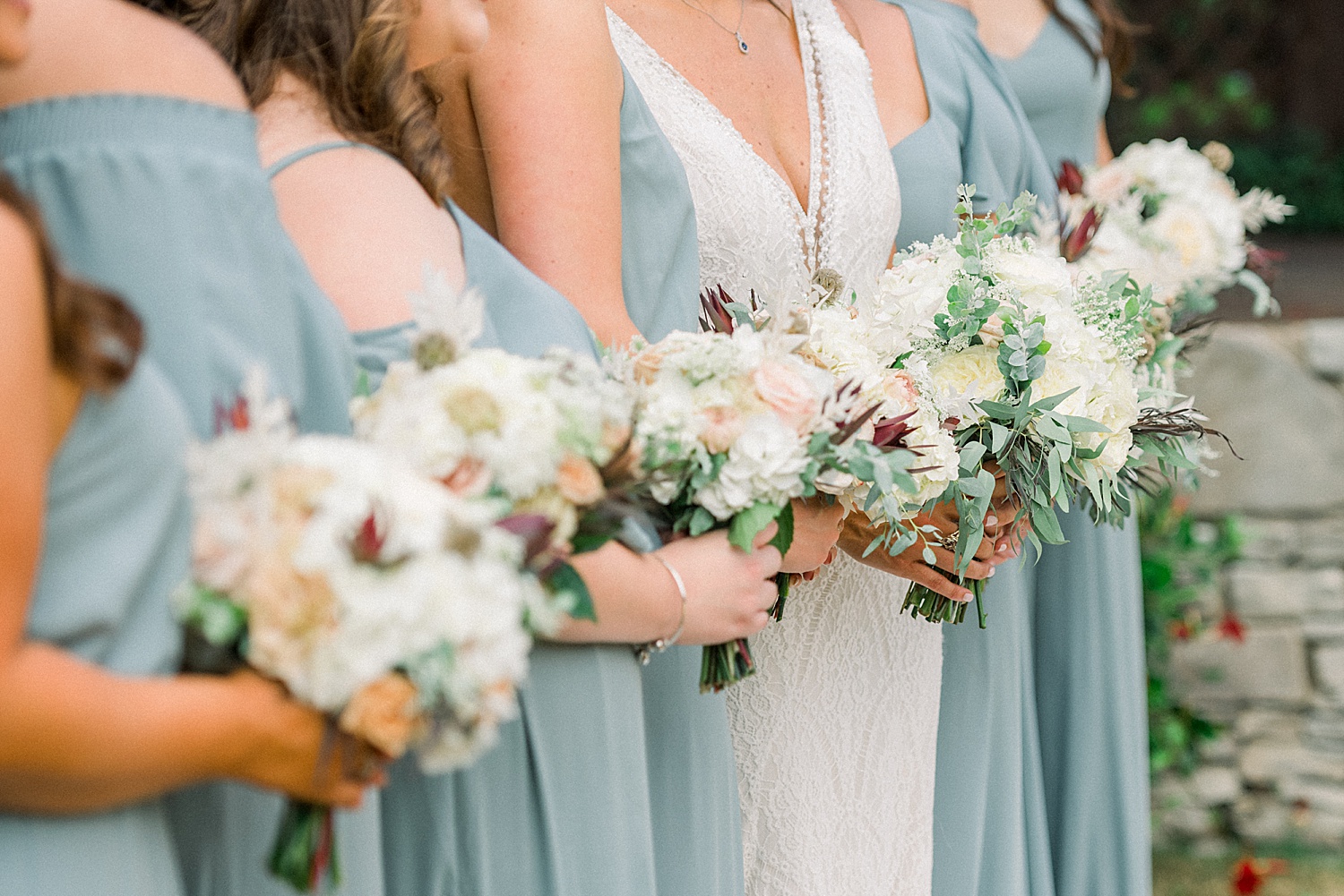 Bridesmaids holding flower bouquets