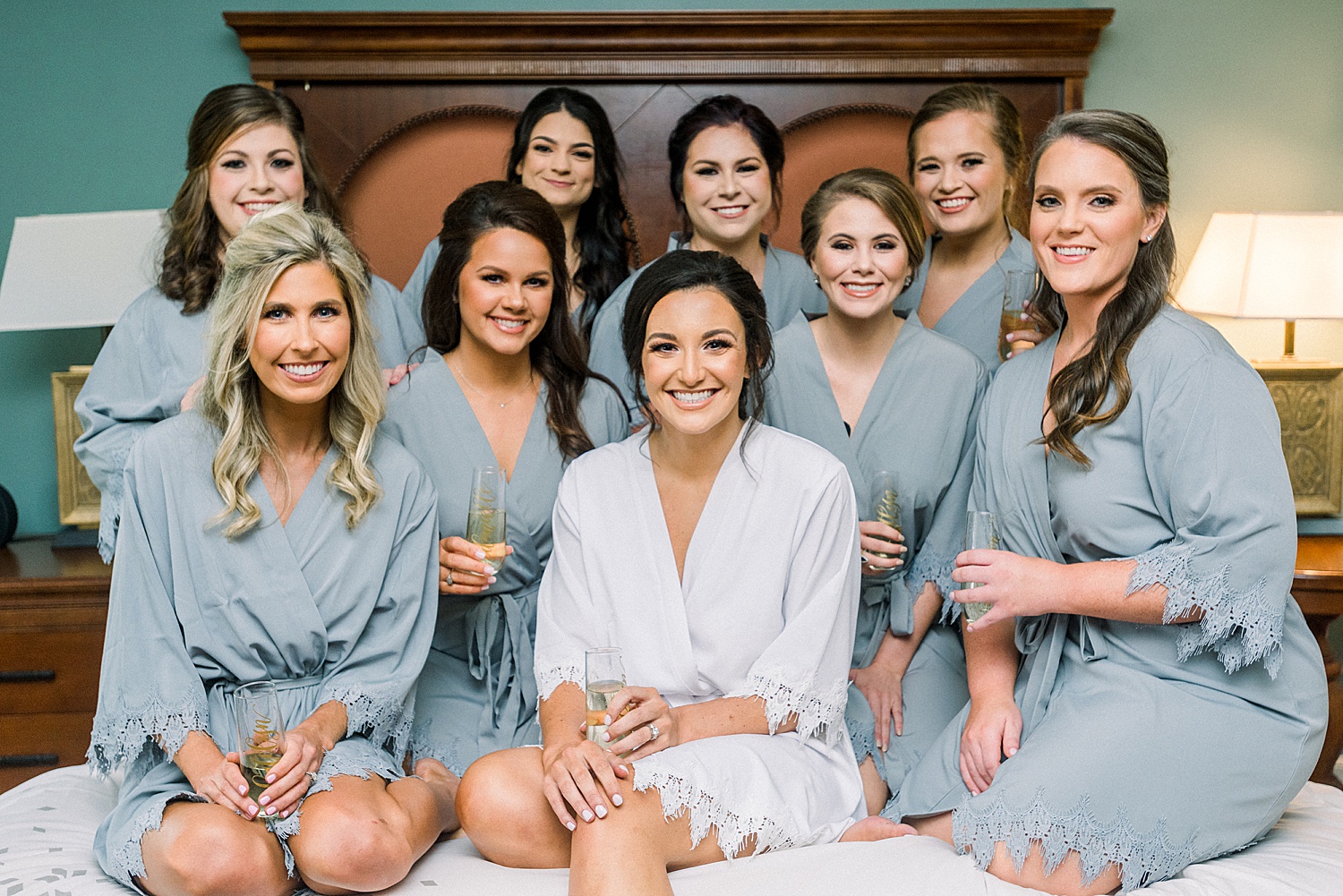 bride + bridesmaids in matching robes getting ready for wedding