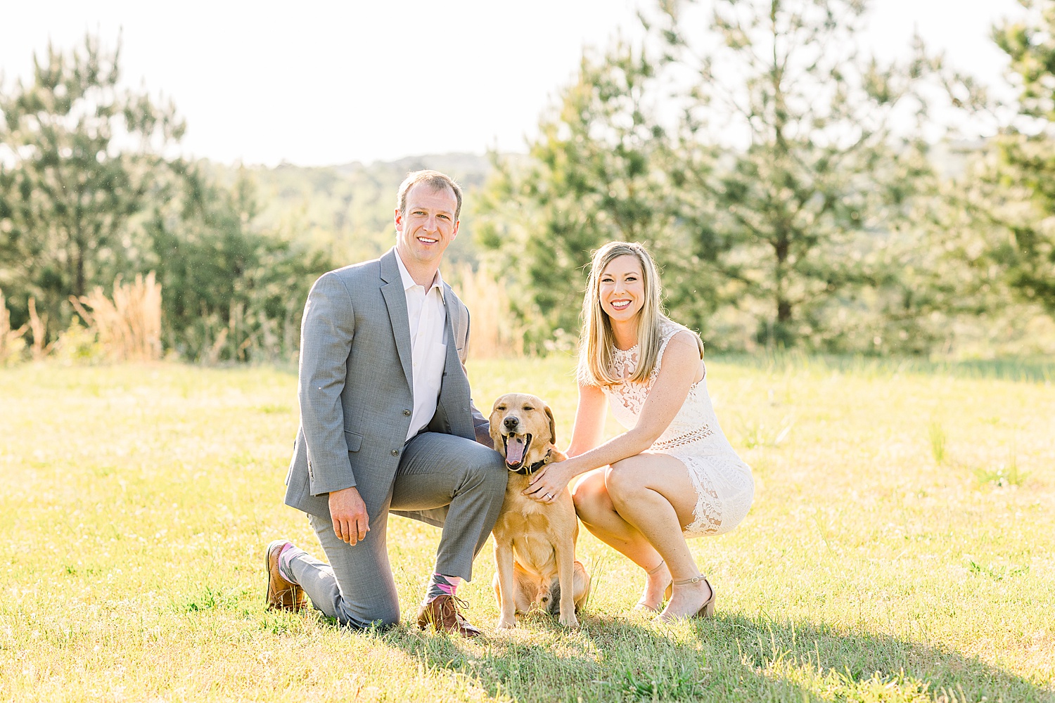 couple pose with their dog during engagement session in AL