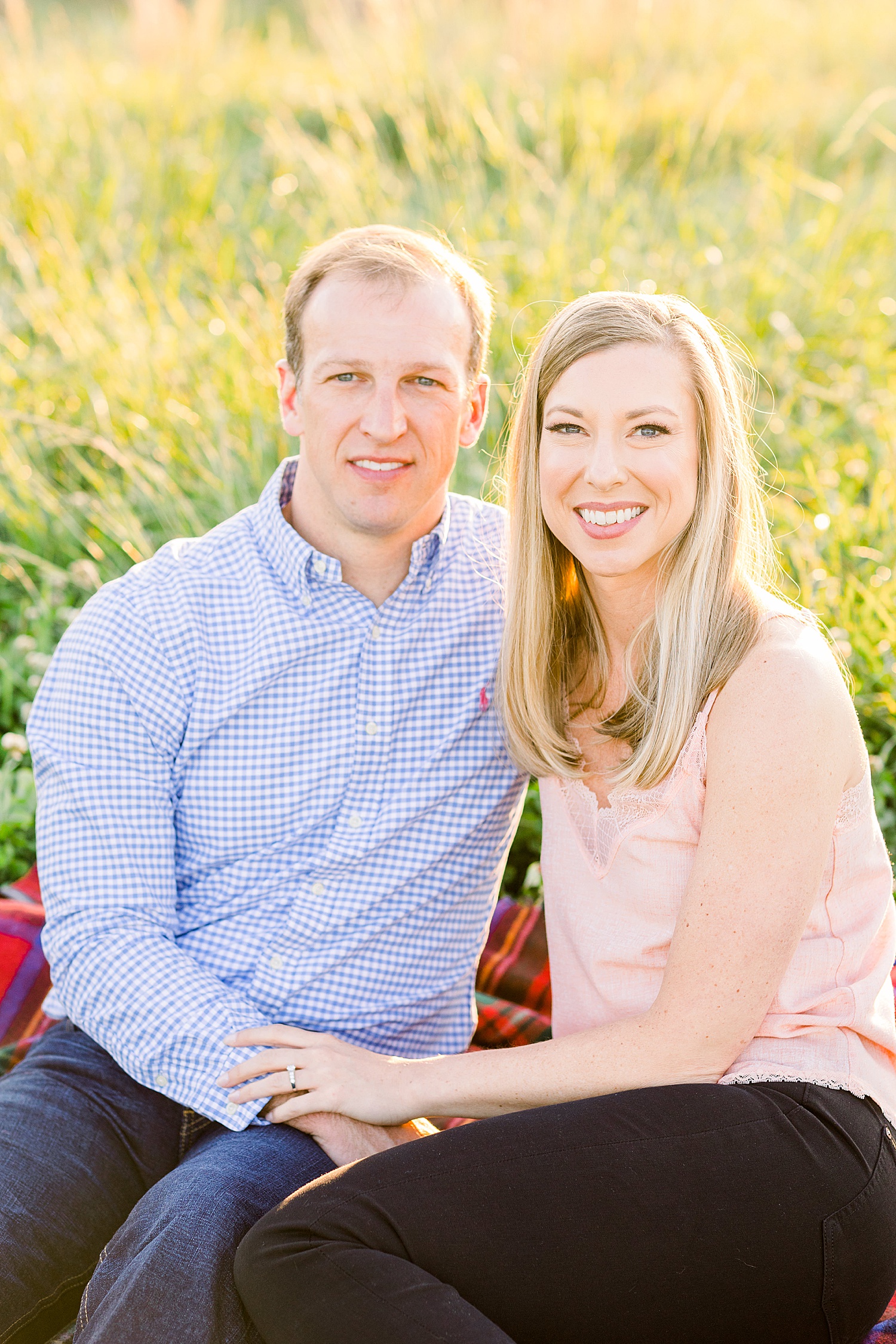 couple sit on blanket during Birmingham Summer Engagement Session