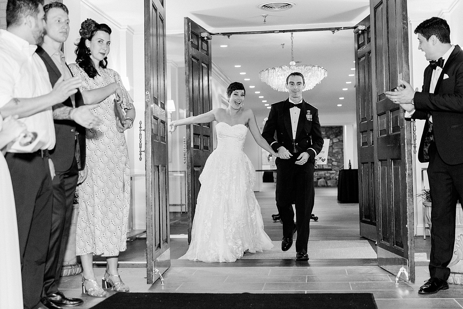 newlyweds greeted by guests as the walk out of the Temple Emanuel