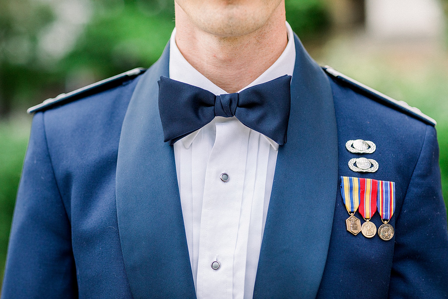 close up of groom's suit and badges