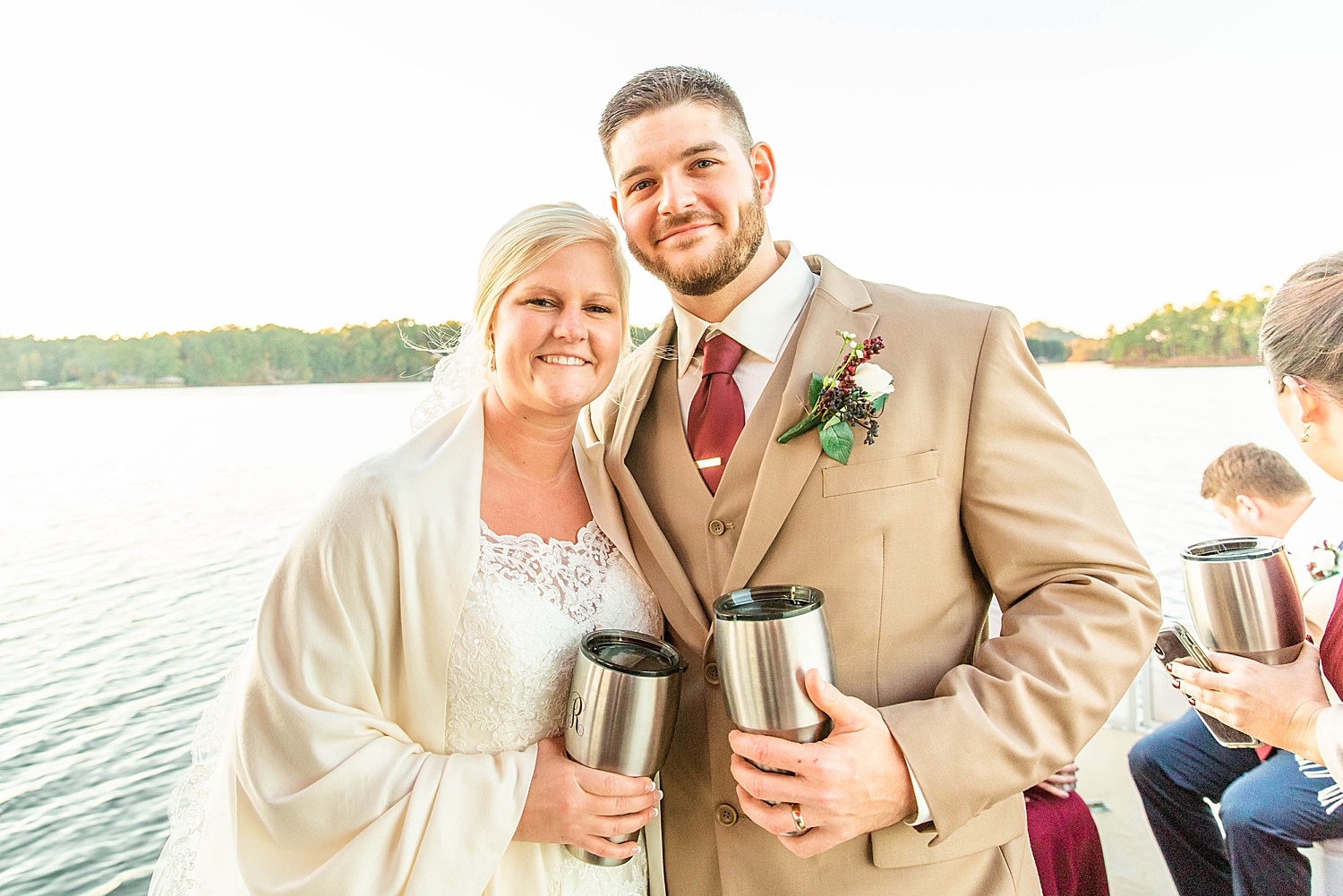 husband and wife hold matching cups at reception
