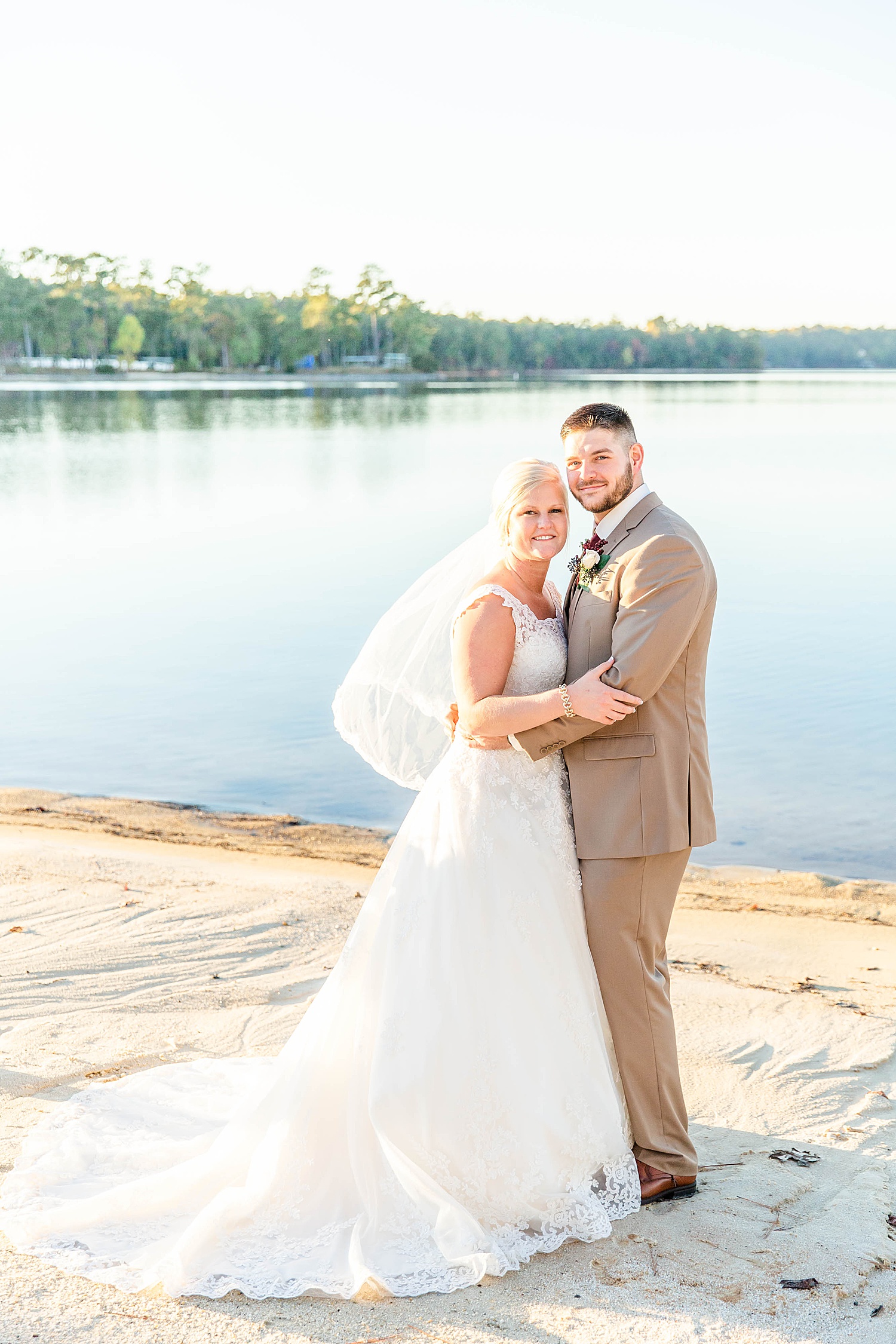 couple pose by AL Lake Martin at New Water Farms