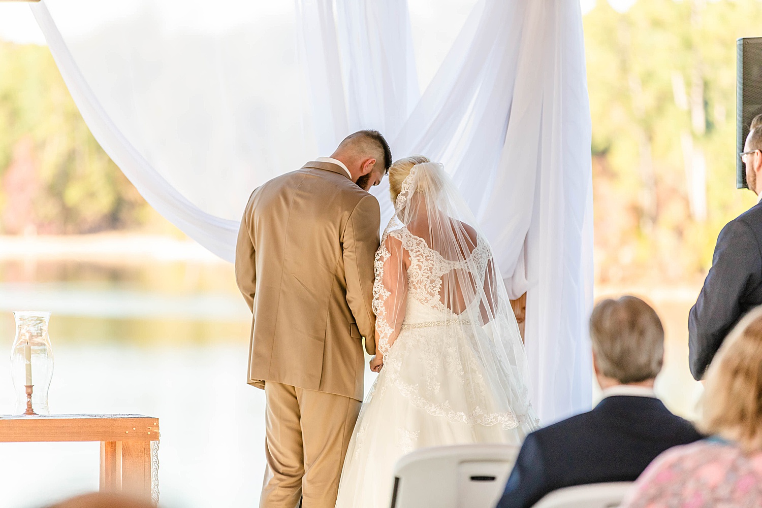 couple pray during AL Lake Martin wedding ceremony