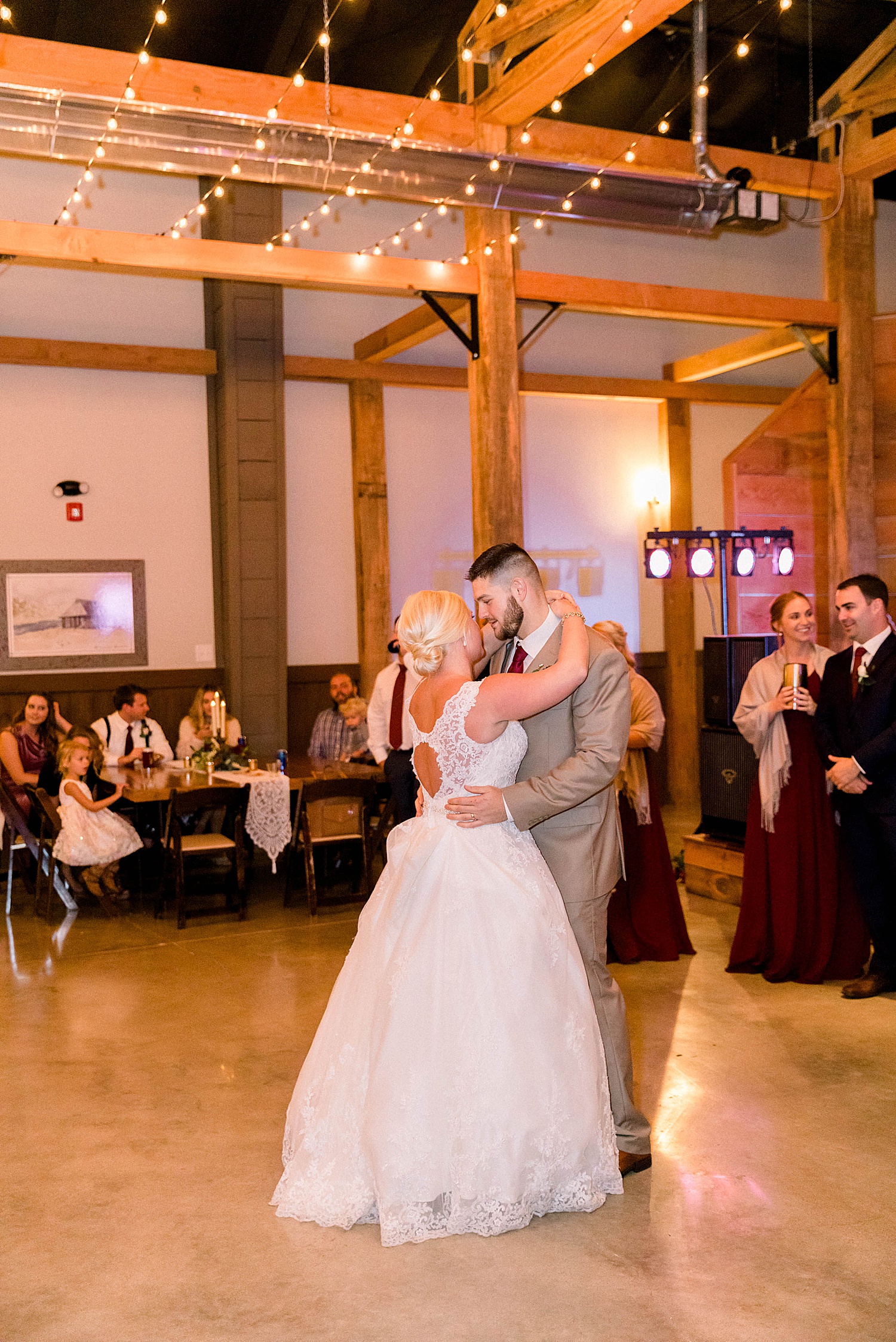 husband and wife share first dance at wedding reception