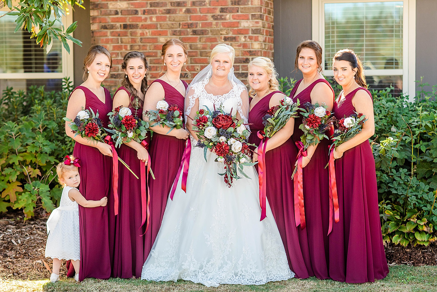 Bride with her bridesmaids in red