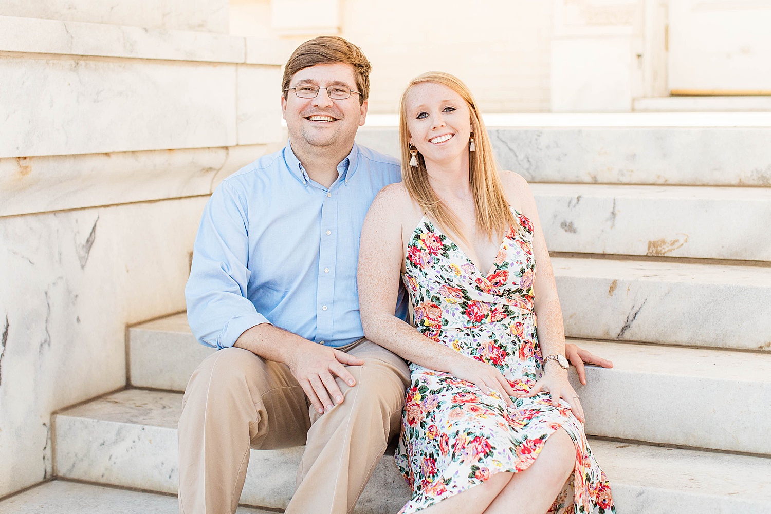 Couple sits on stairs during Downtown Birmingham Engagement session