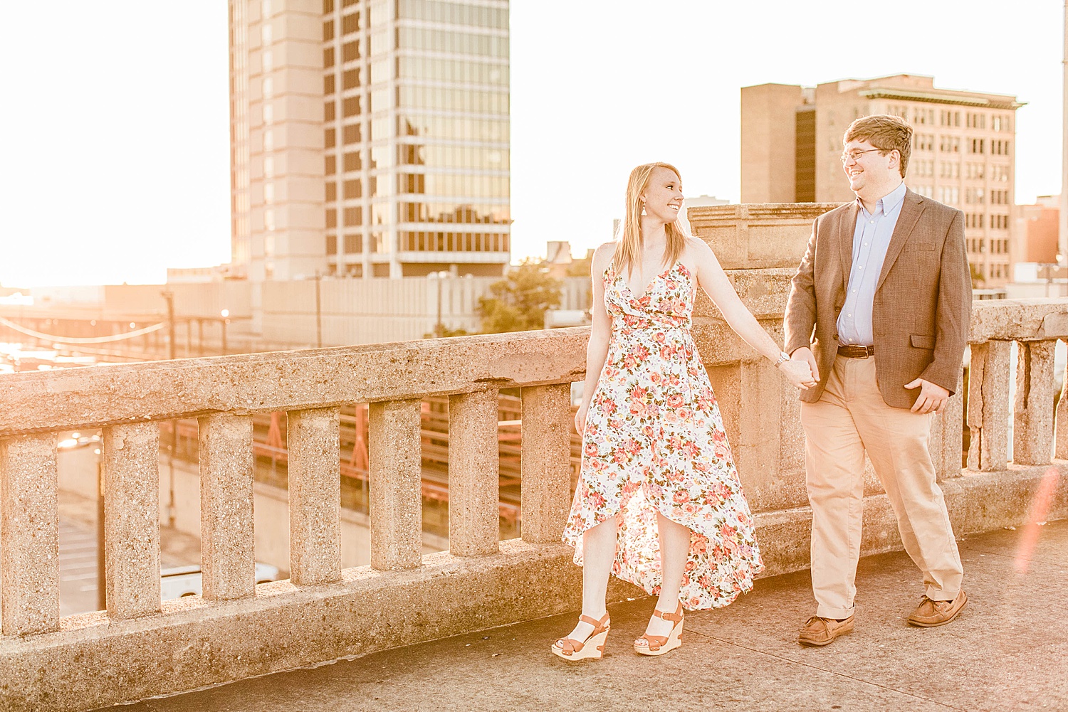 engaged couple hold hands on building rooftop in Downtown Birmingham Alabama