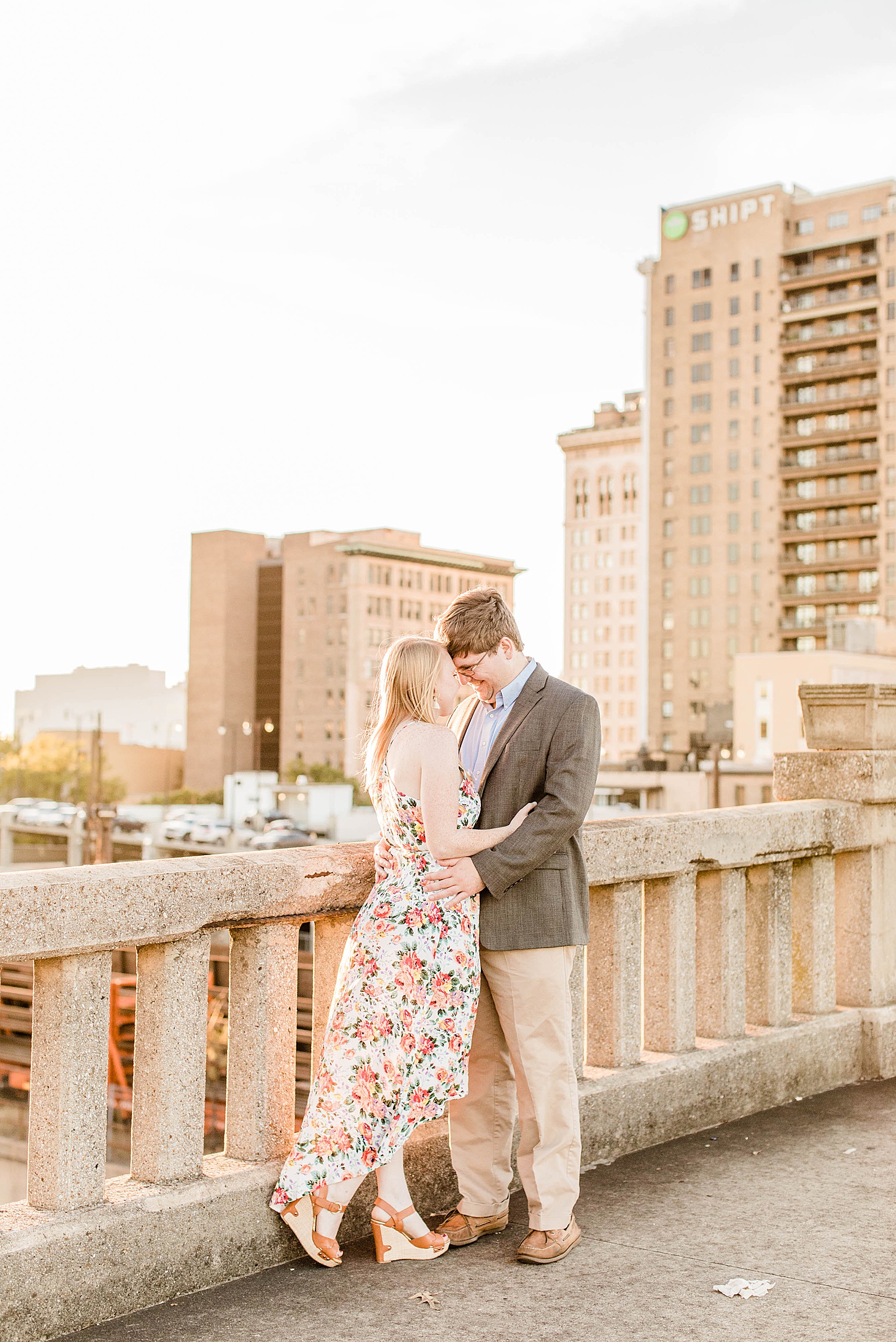 couple lean in to each other during intimate moment of engagement session in Downtown Birmingham Alabama