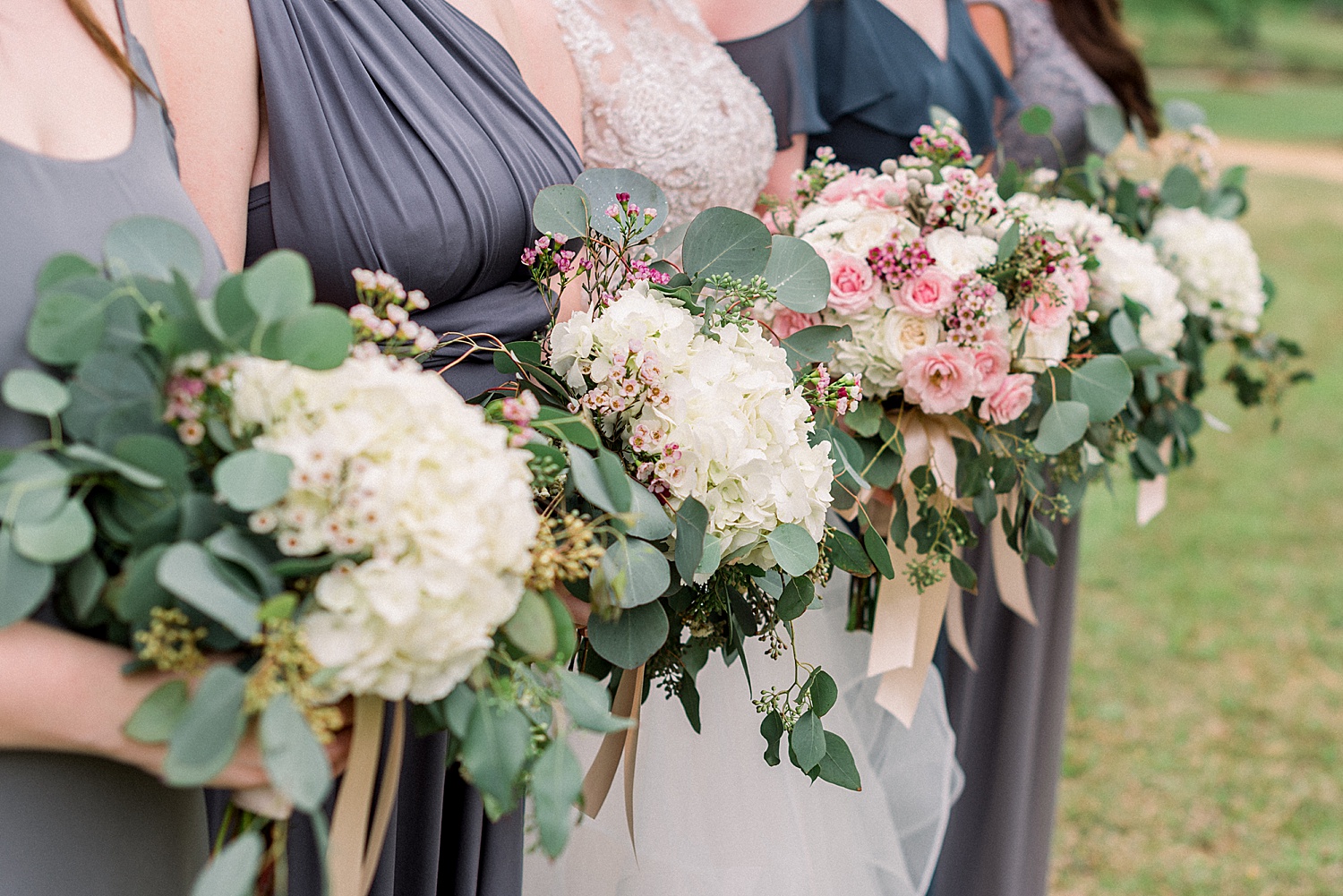 bride and bridesmaids flower bouquets together before AL wedding ceremony