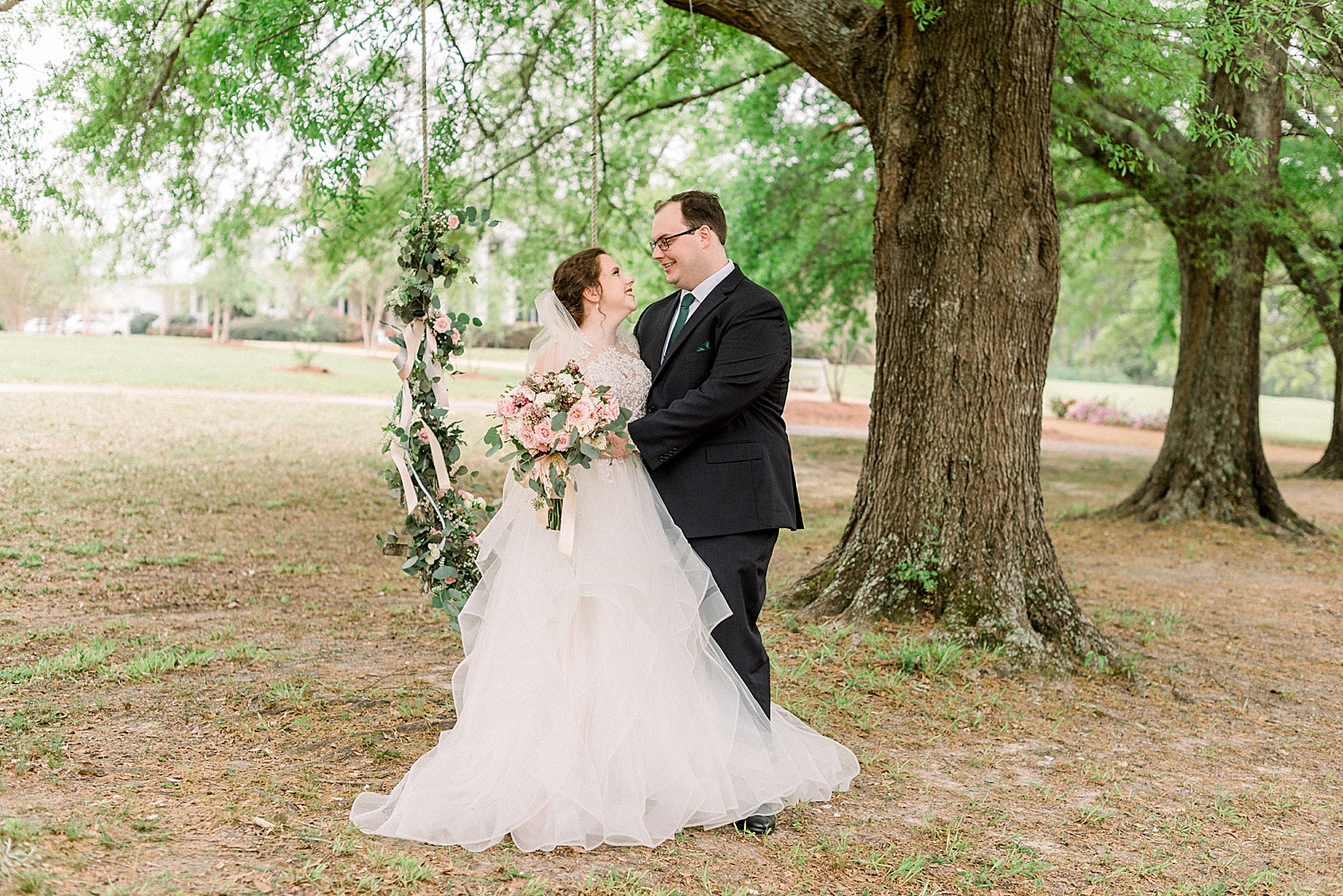 bride and groom under tree on the grounds of Tangarray Wedding venue