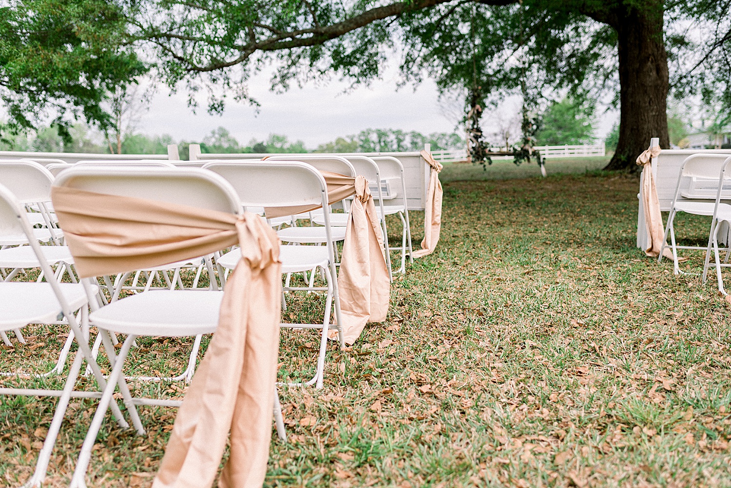Chairs draped in pink cloth for Romantic Tangarray AL Wedding Ceremony in Eclectic Alabama