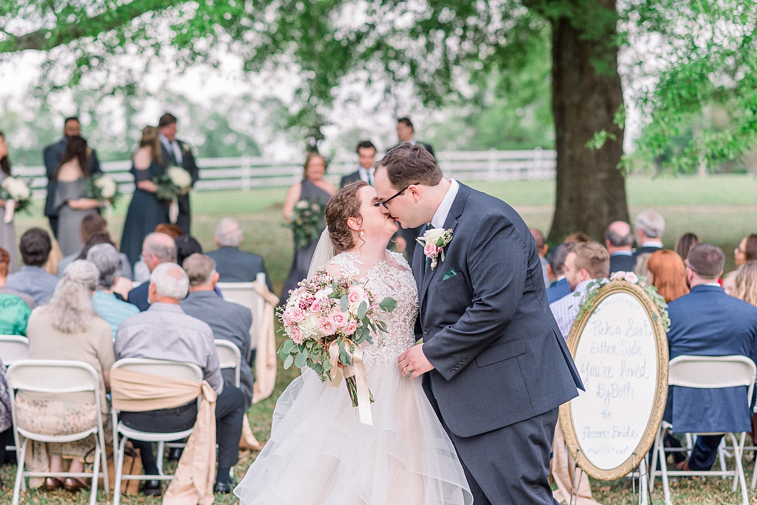 couple kiss at the end of aisle of wedding