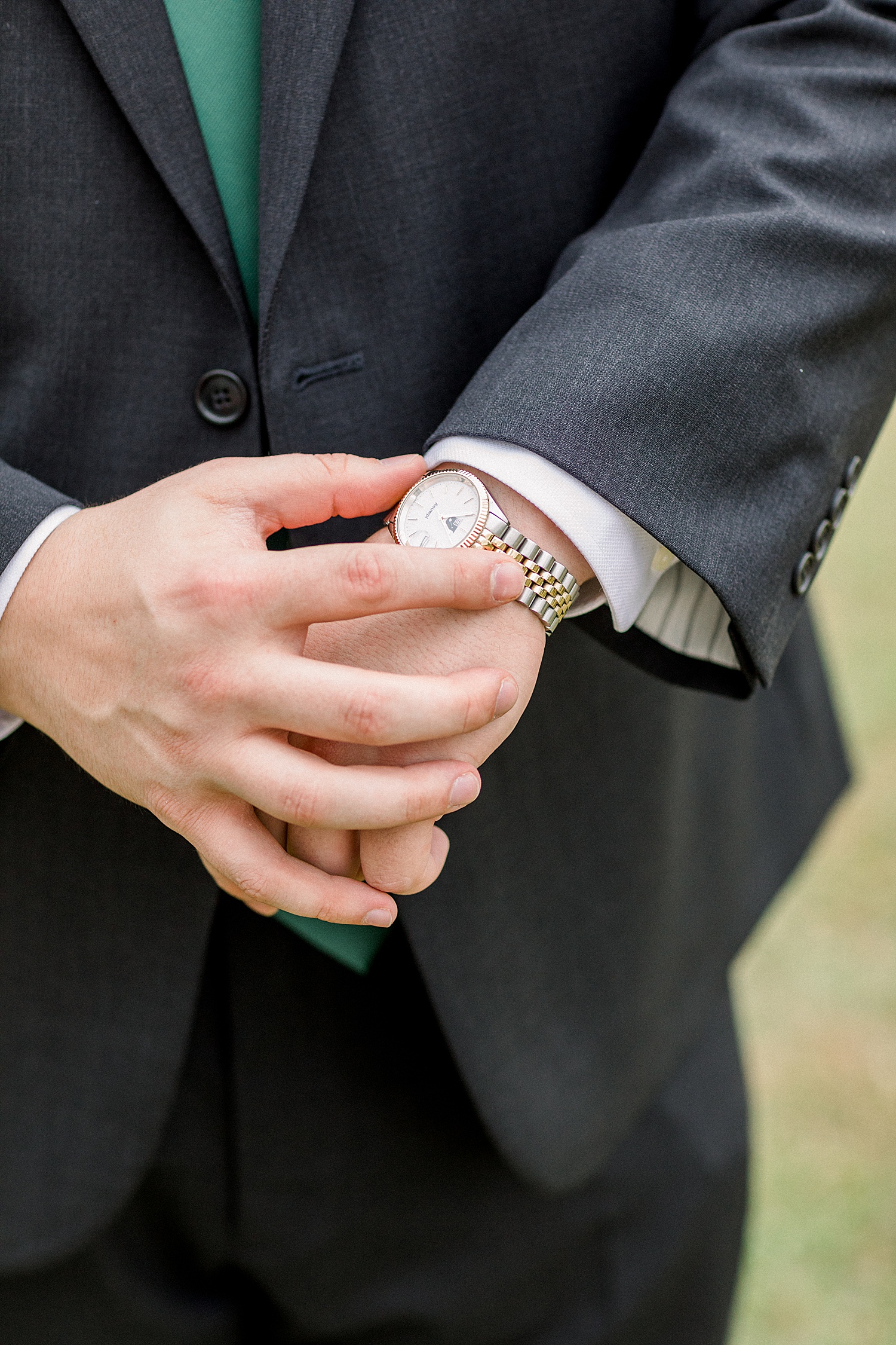 groom checks watch waiting to see bride