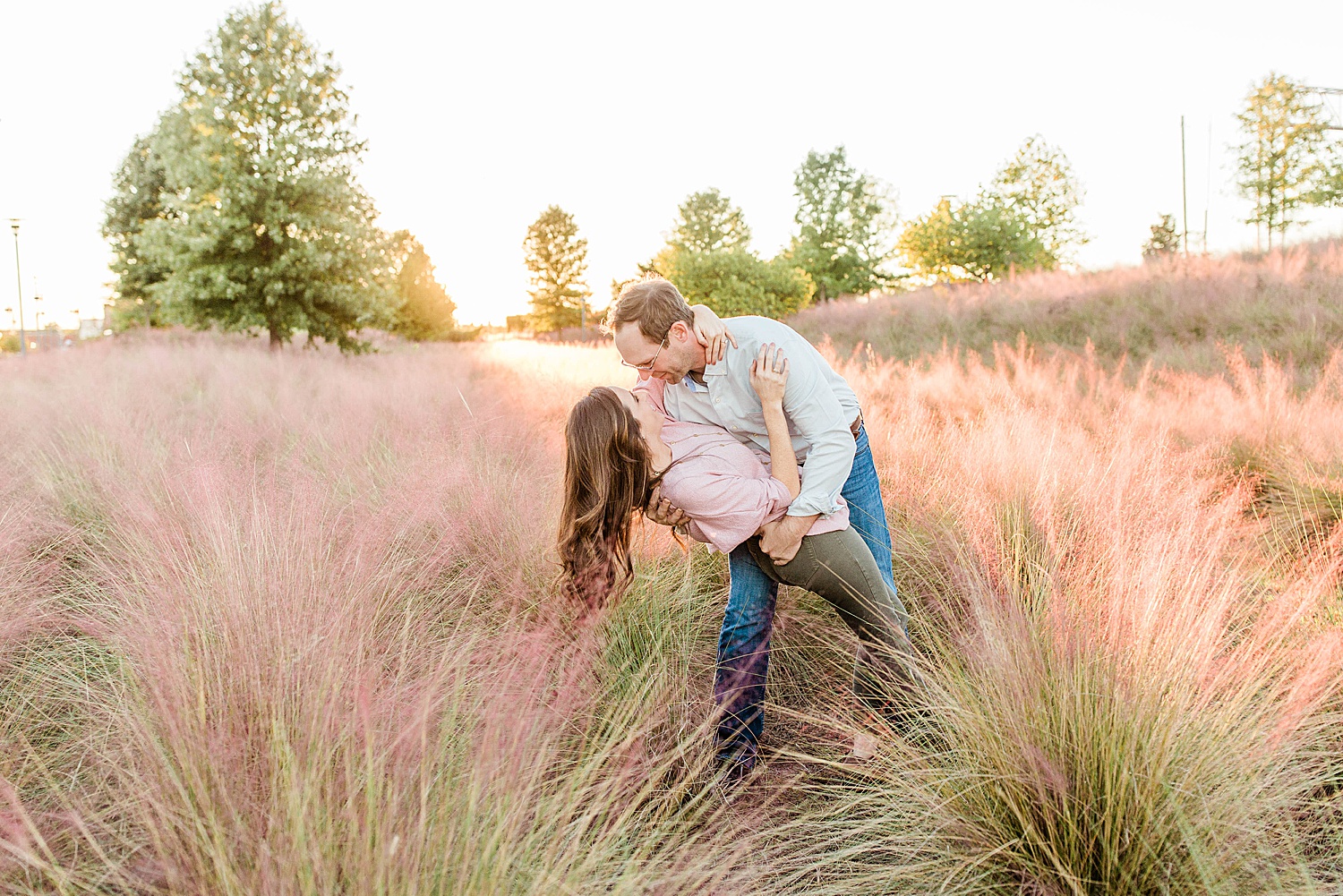 man dips his fiancé in the purple grass at railroad park in Birmingham AL