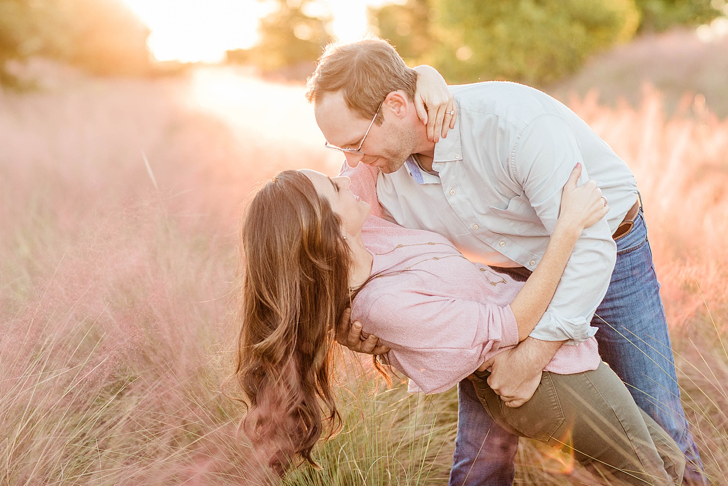 man dips his fiancé in the purple grass at railroad park in Birmingham AL
