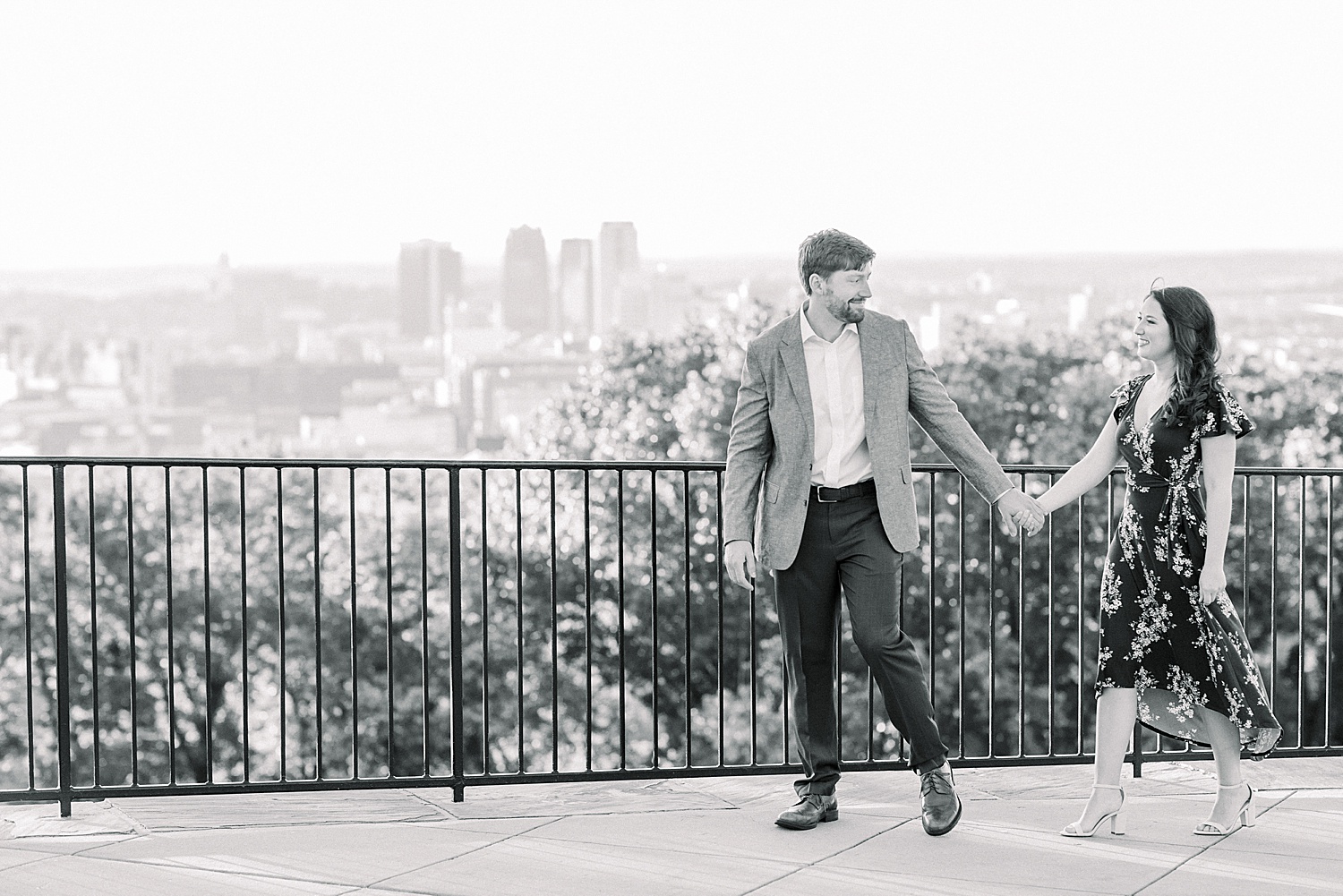 couple on balcony at Vulcan Park with city skyline in the background in Birmingham, AL