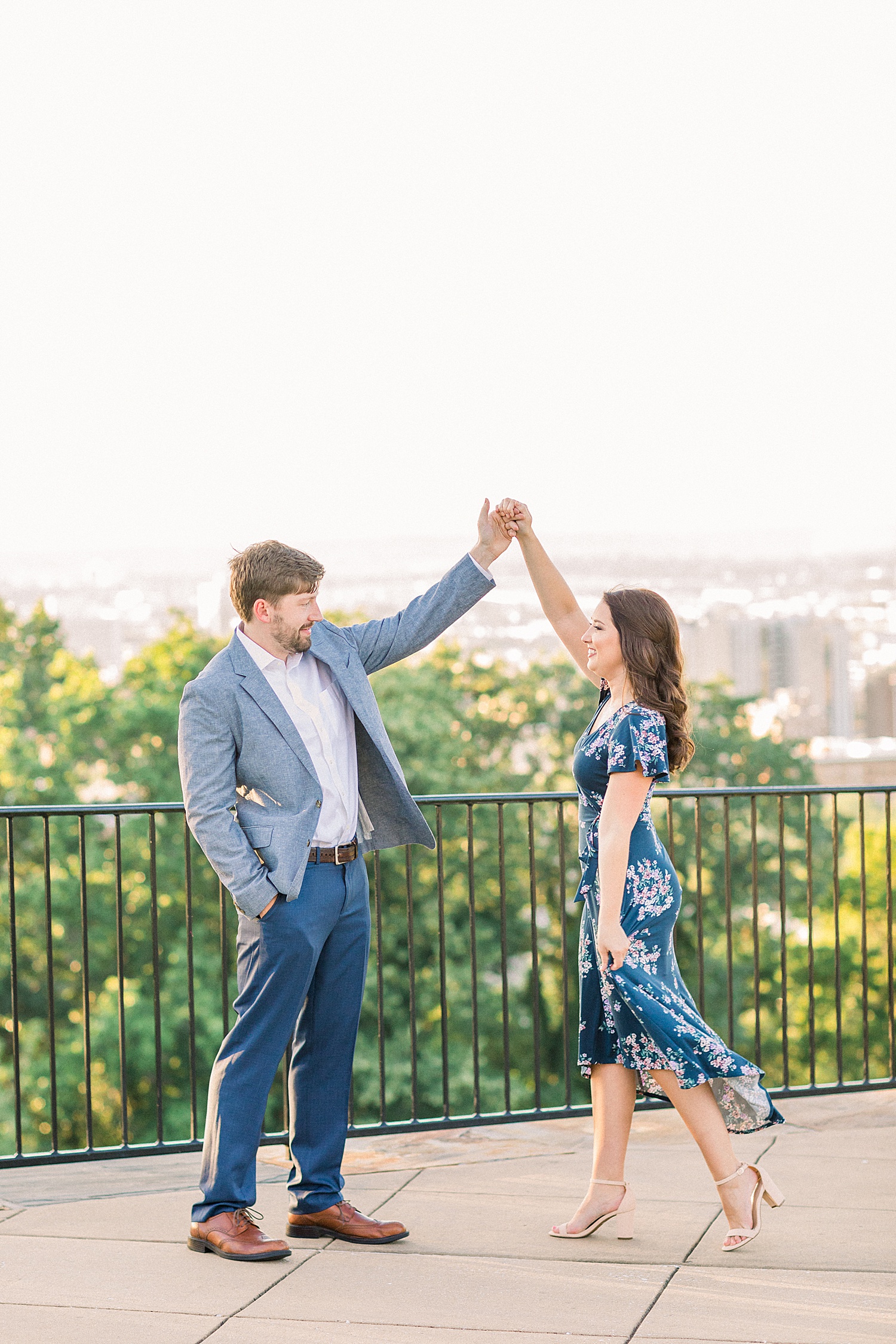 couple dancing on balcony during engagement photos