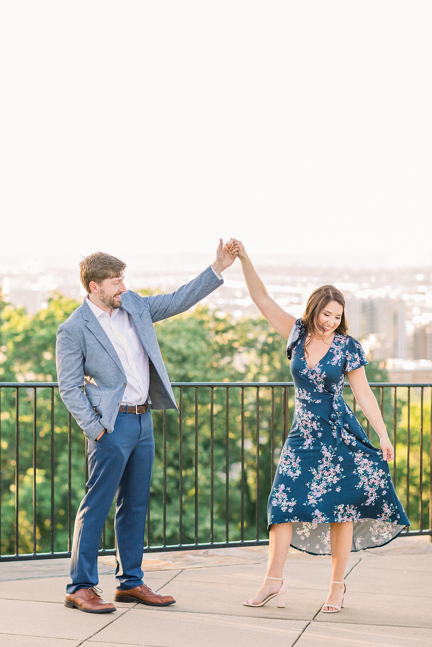 couple dancing on balcony during AL engagement photos