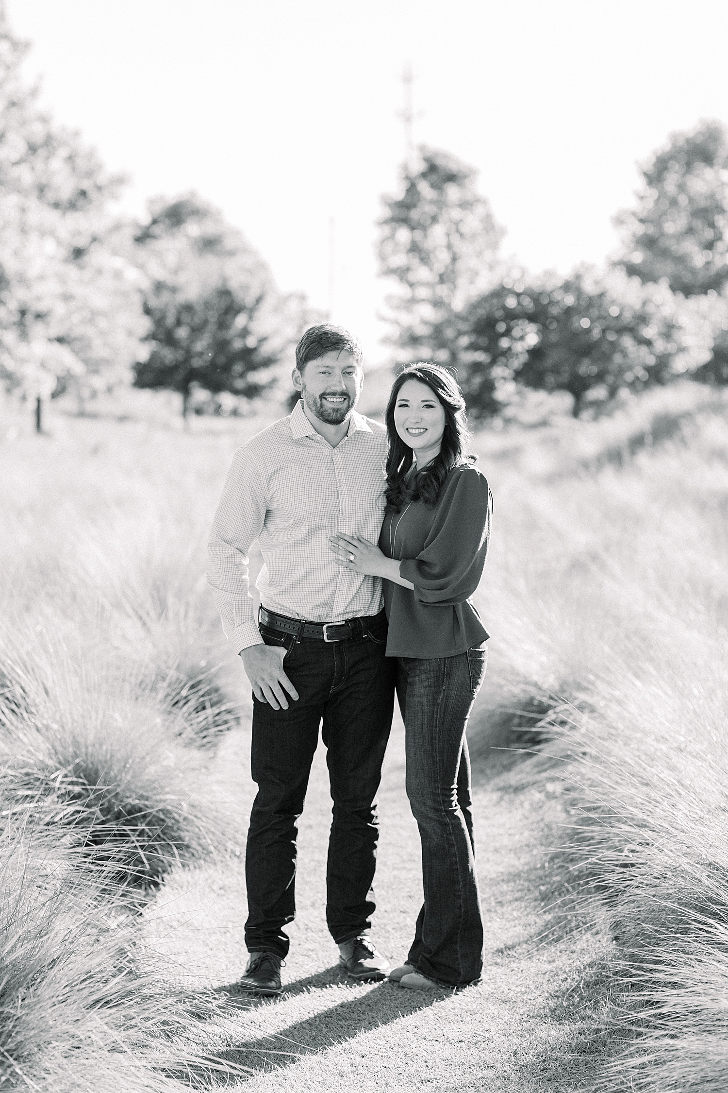 black and white photo of couple in grass during engagement photos
