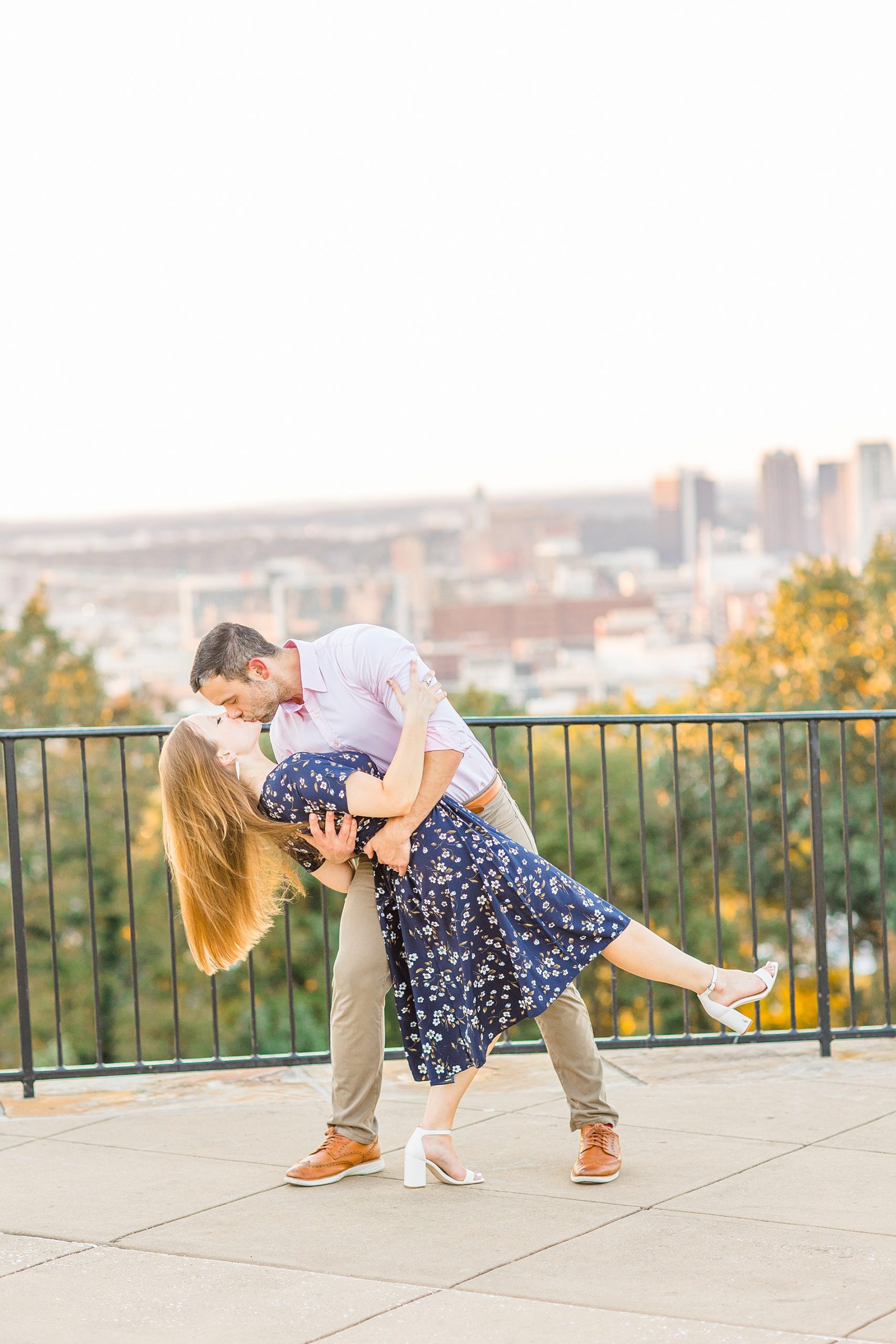 man dips his fiance overlooking the city skyline -Birmingham Alabama Engagement Sessions