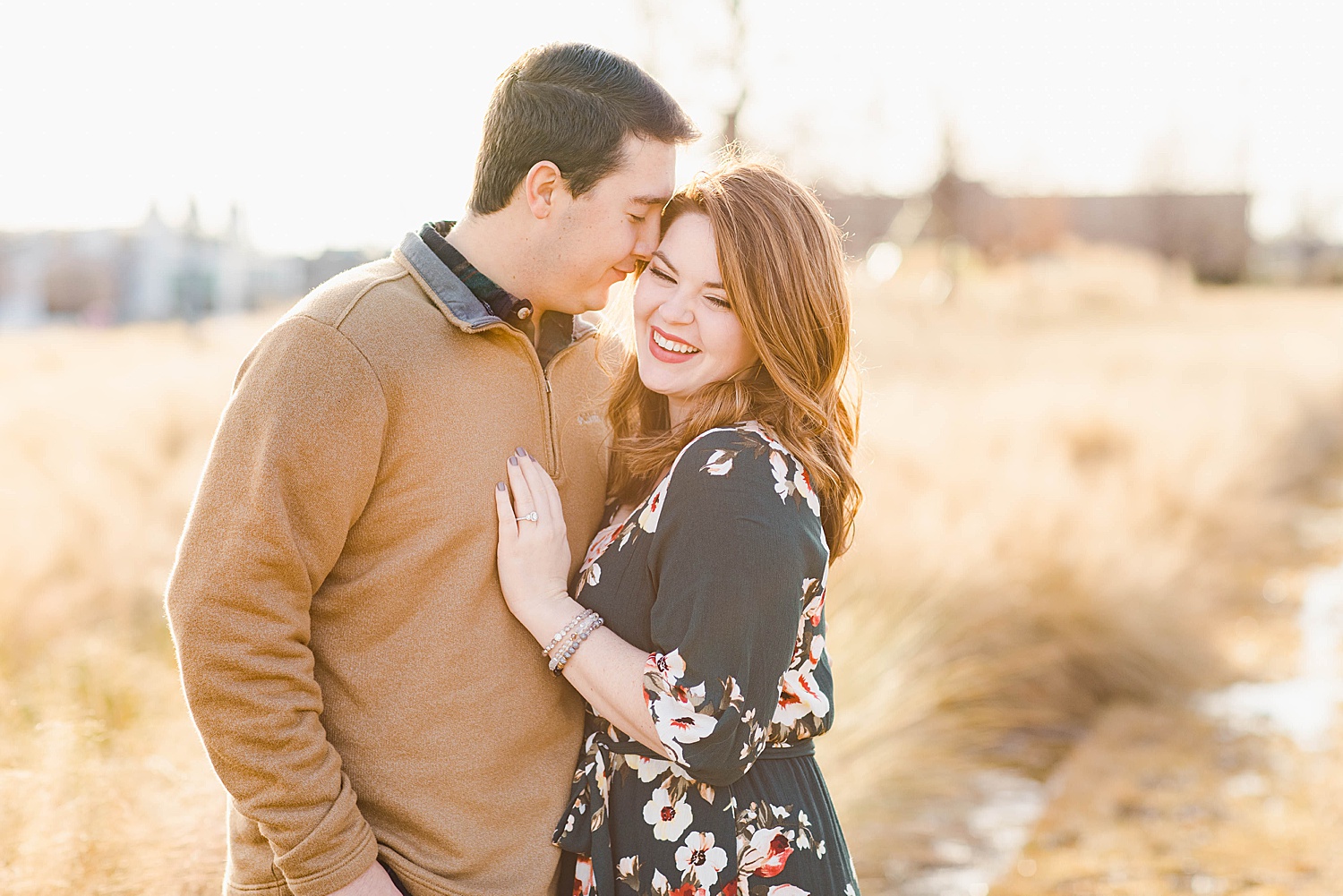 couple snuggle in close for their engagement portraits