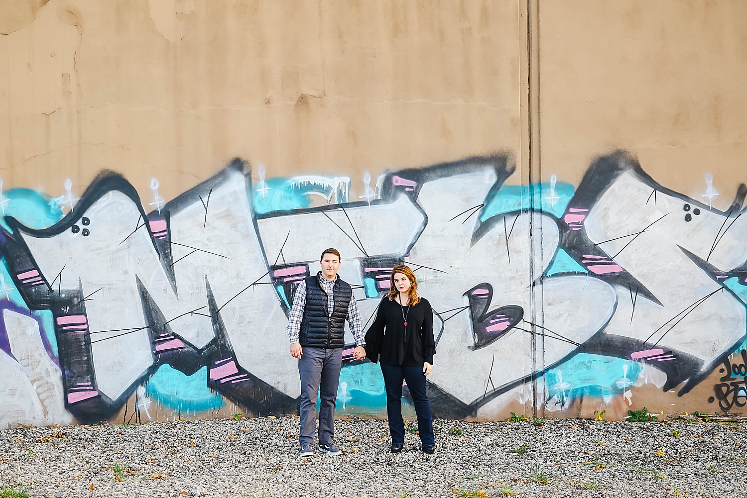 couple in front of graffiti wall