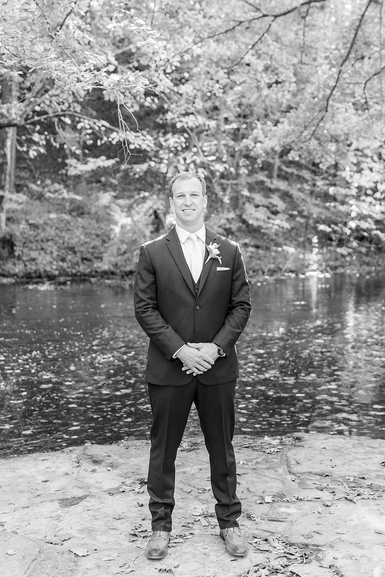 groom standing by river at Swann Lake Stables