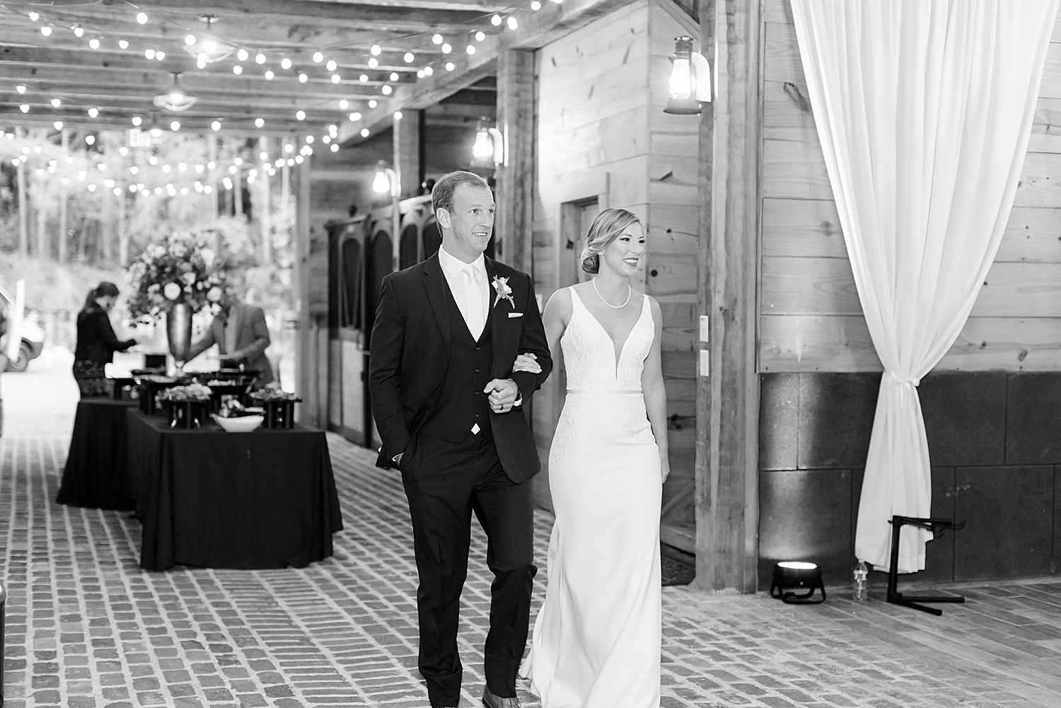 bride and groom walk into reception