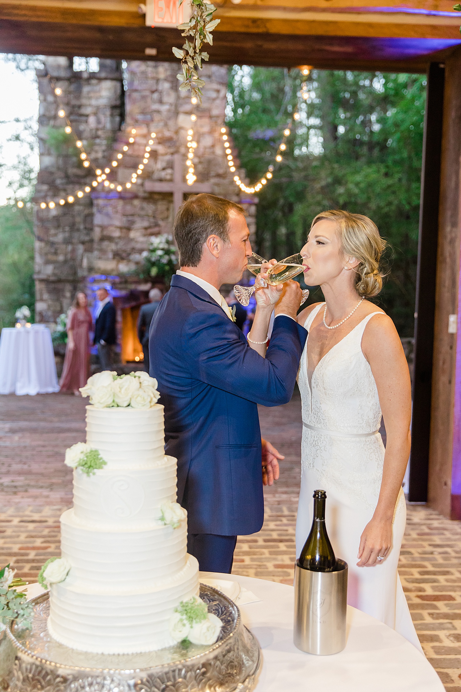 newlyweds eat wedding cake at their Swann Lake Stables Wedding