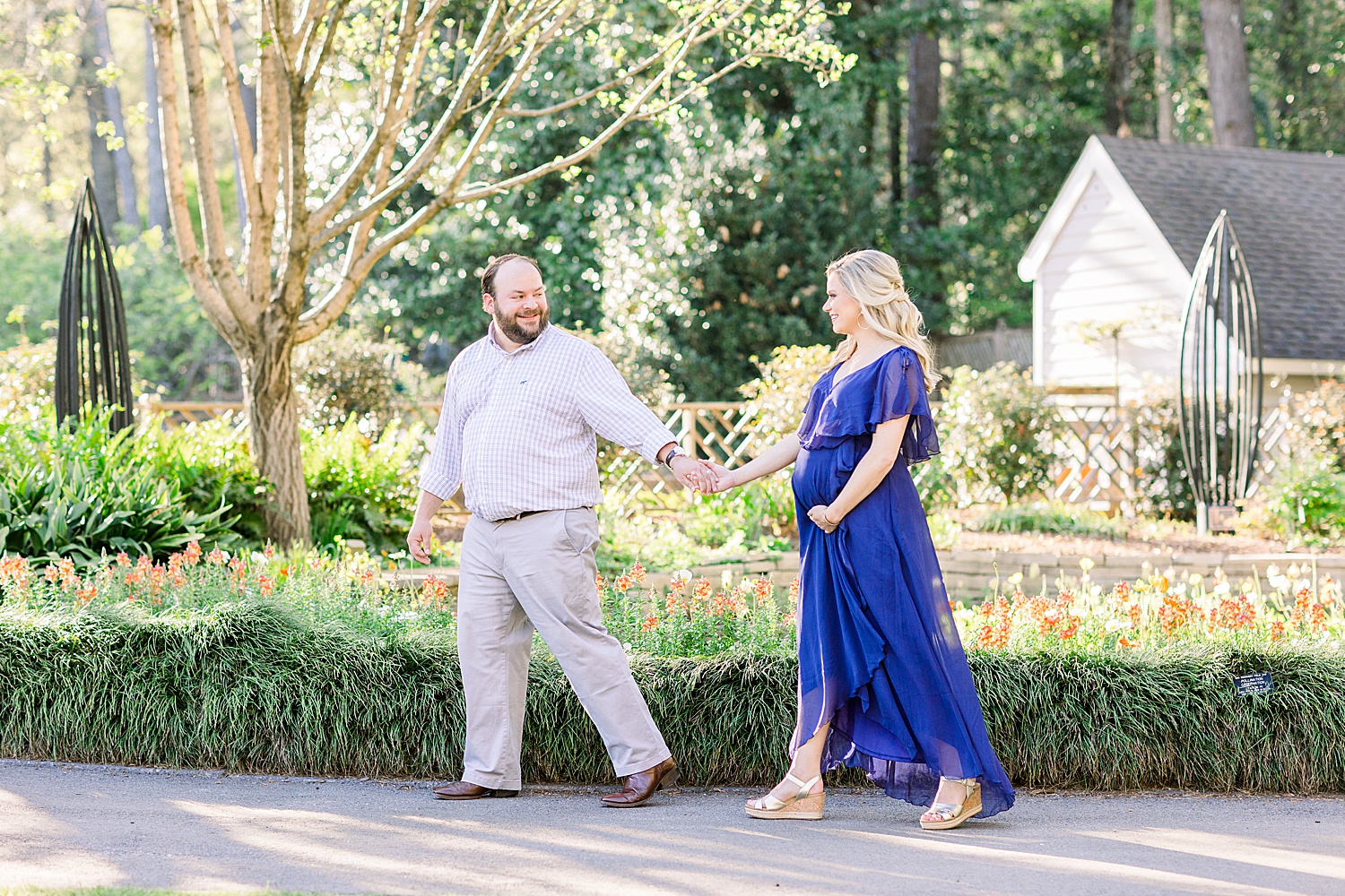 couple walking during Maternity Session at Birmingham Botanical Gardens