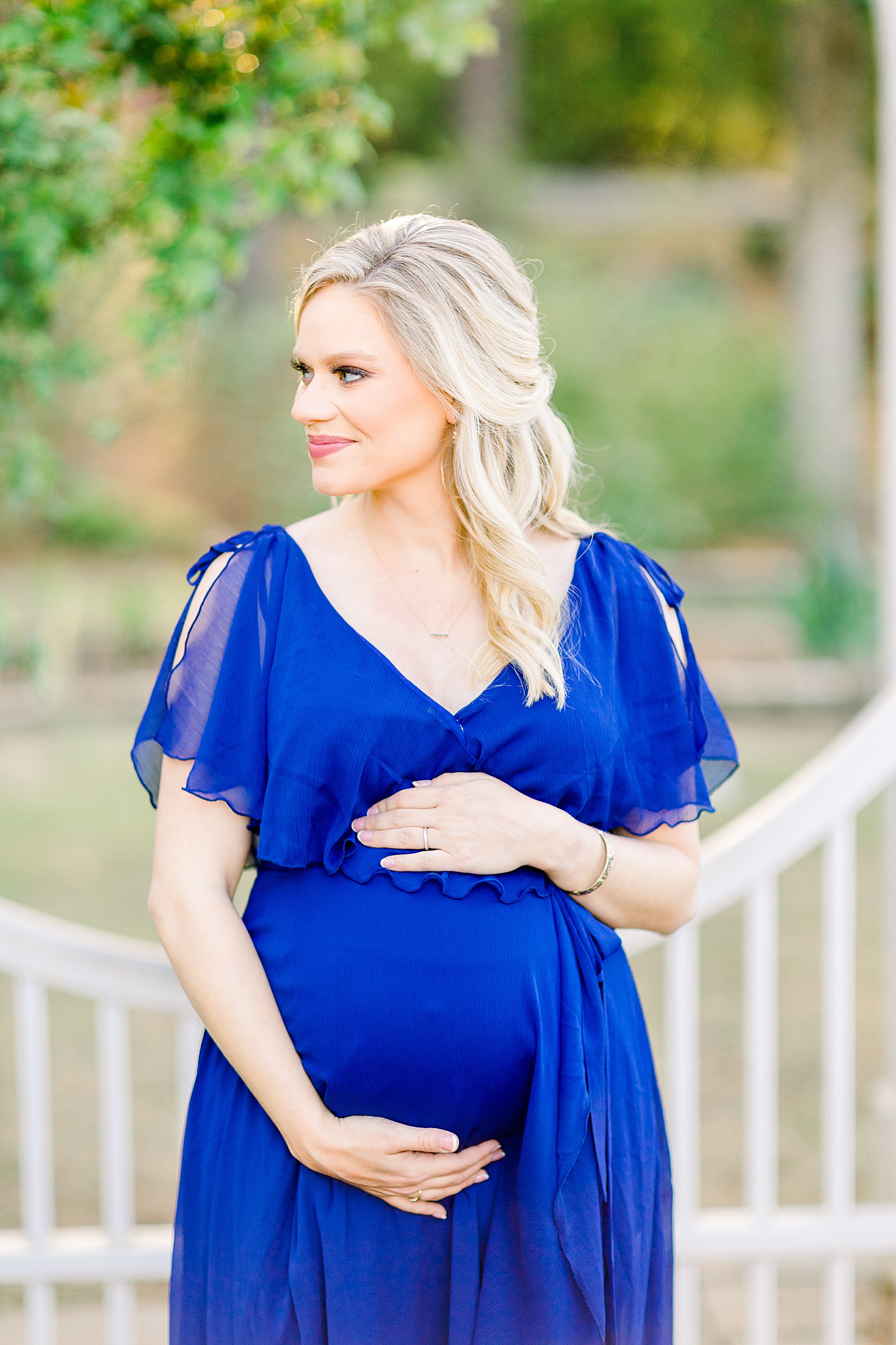 woman shows off baby bump during maternity session