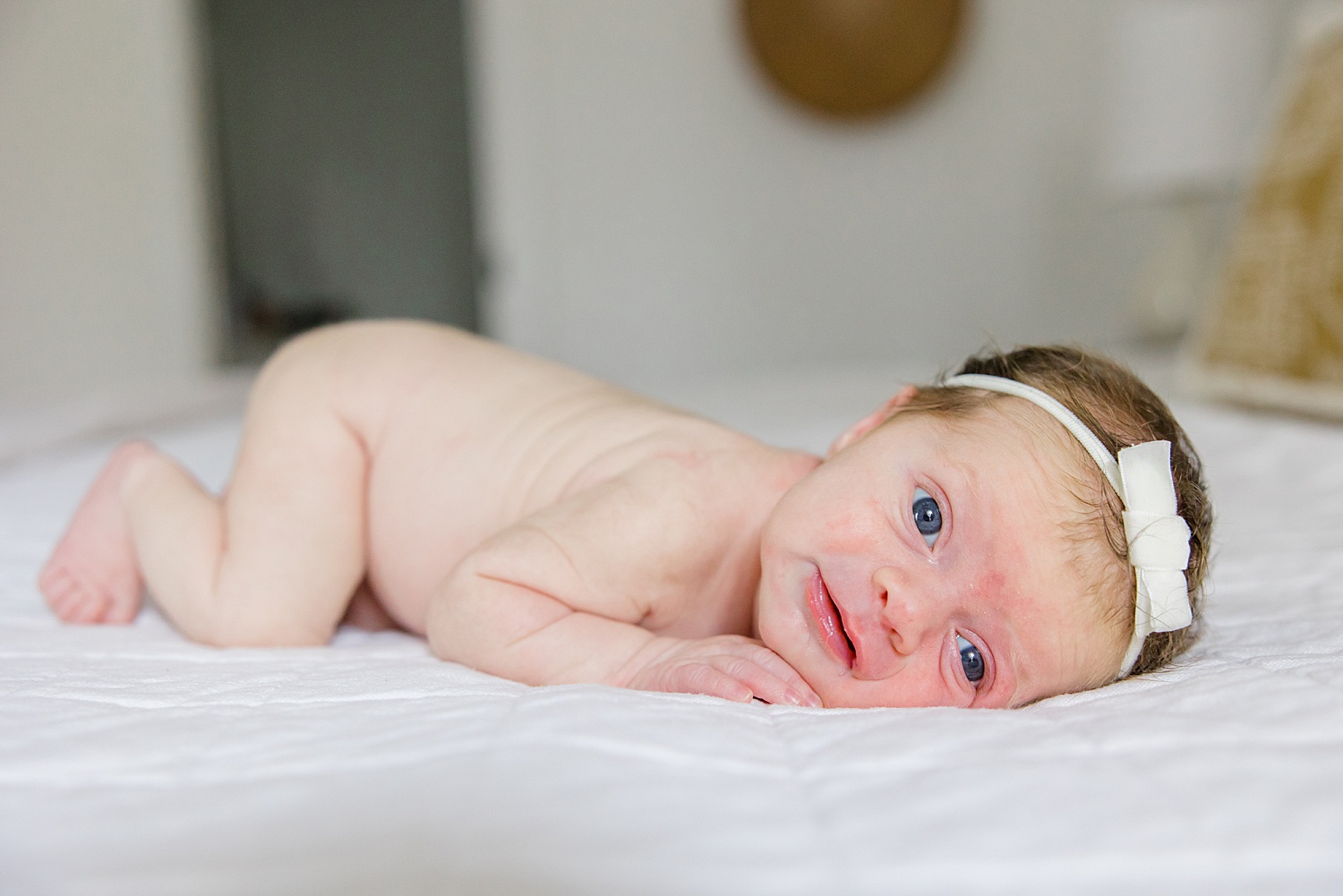 baby girl on bed during birmingham, AL in-home session