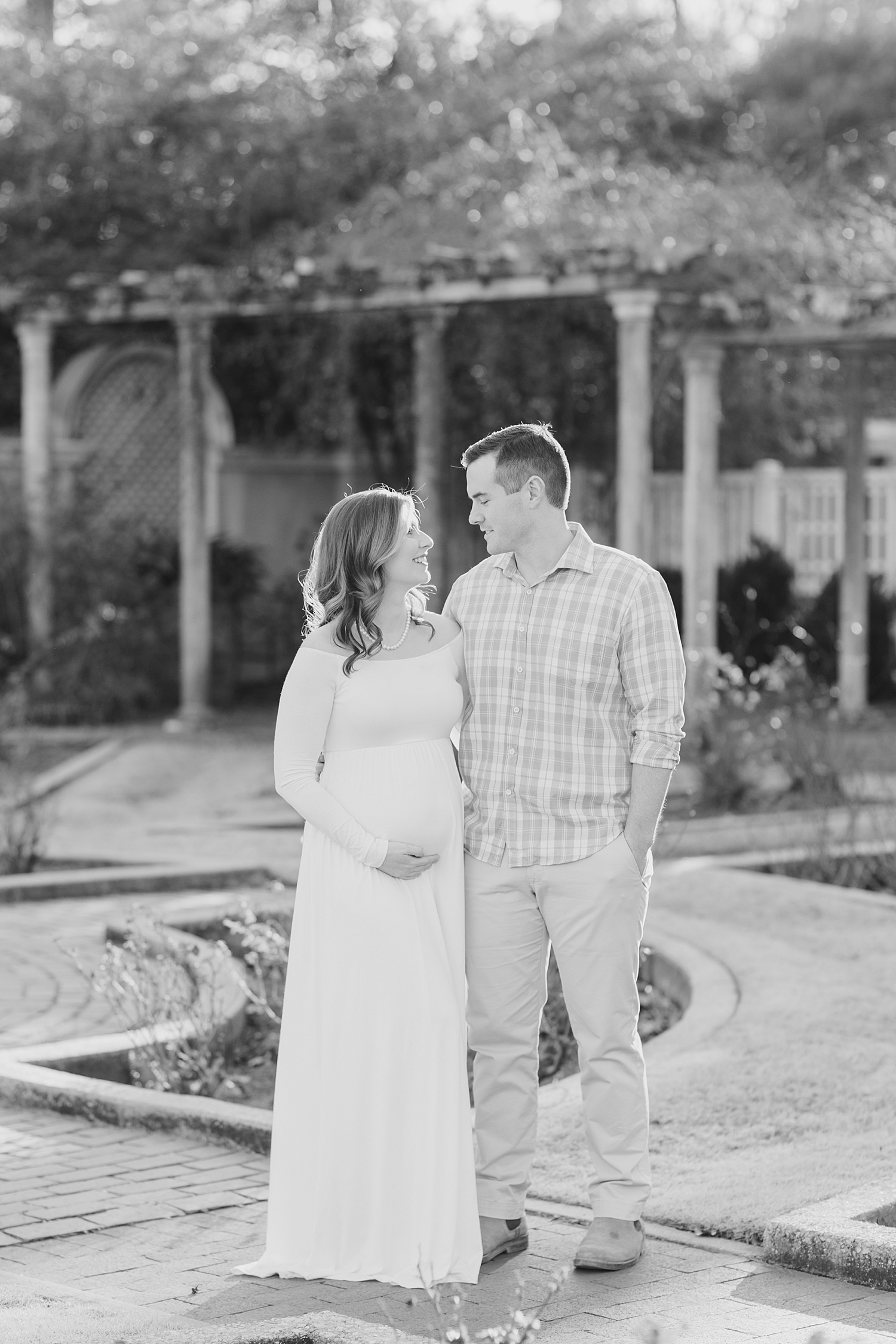 couple stand in garden during Birmingham Maternity session