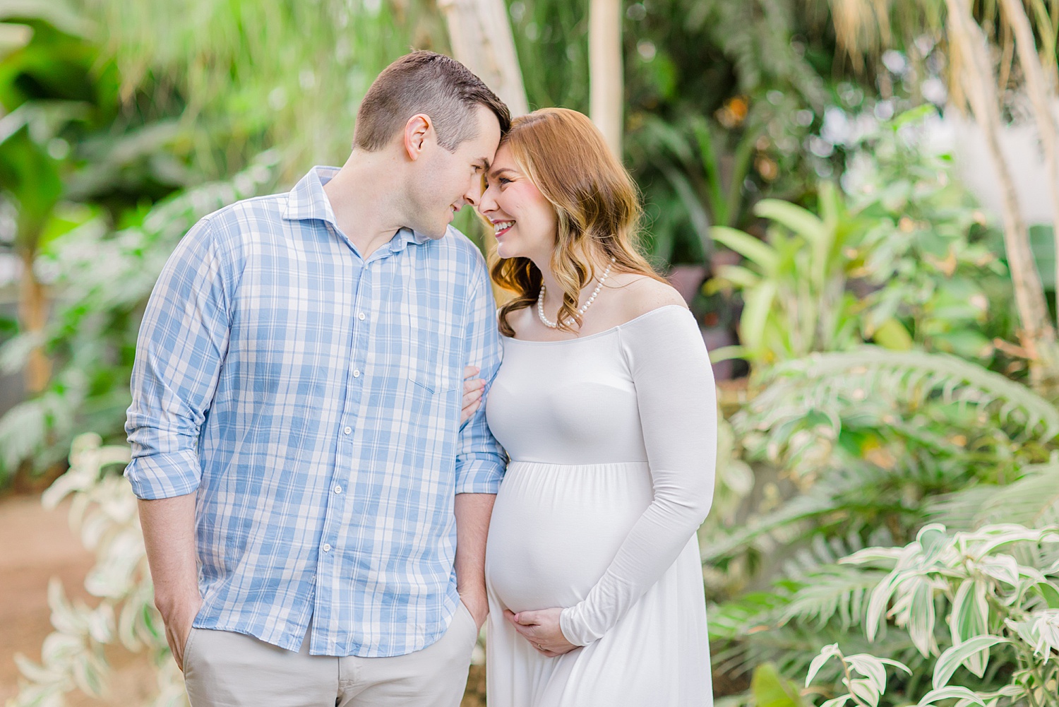 couple leans in together during maternity session