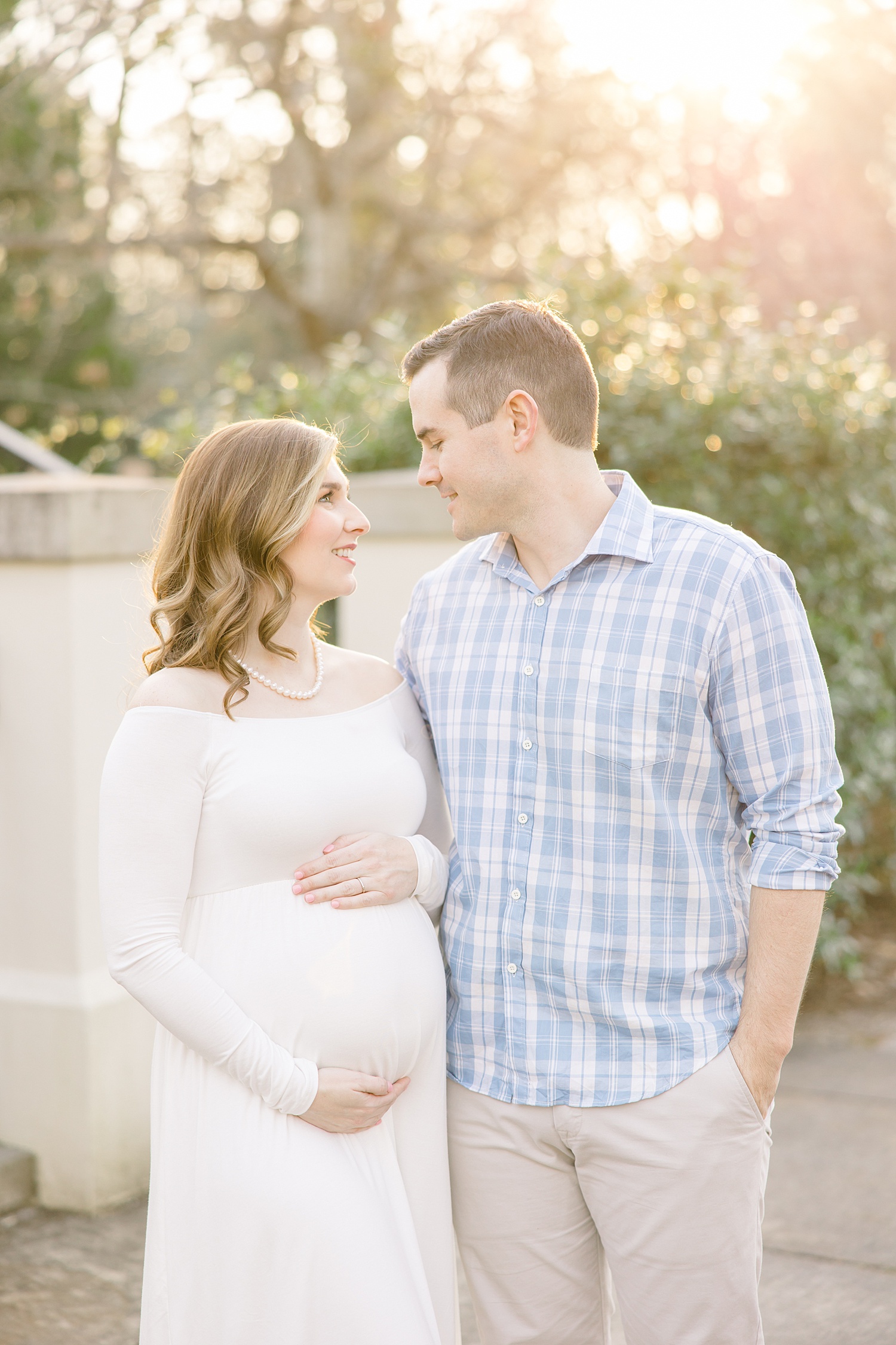 parents-to-be look lovingly at each other during Birmingham AL Maternity session