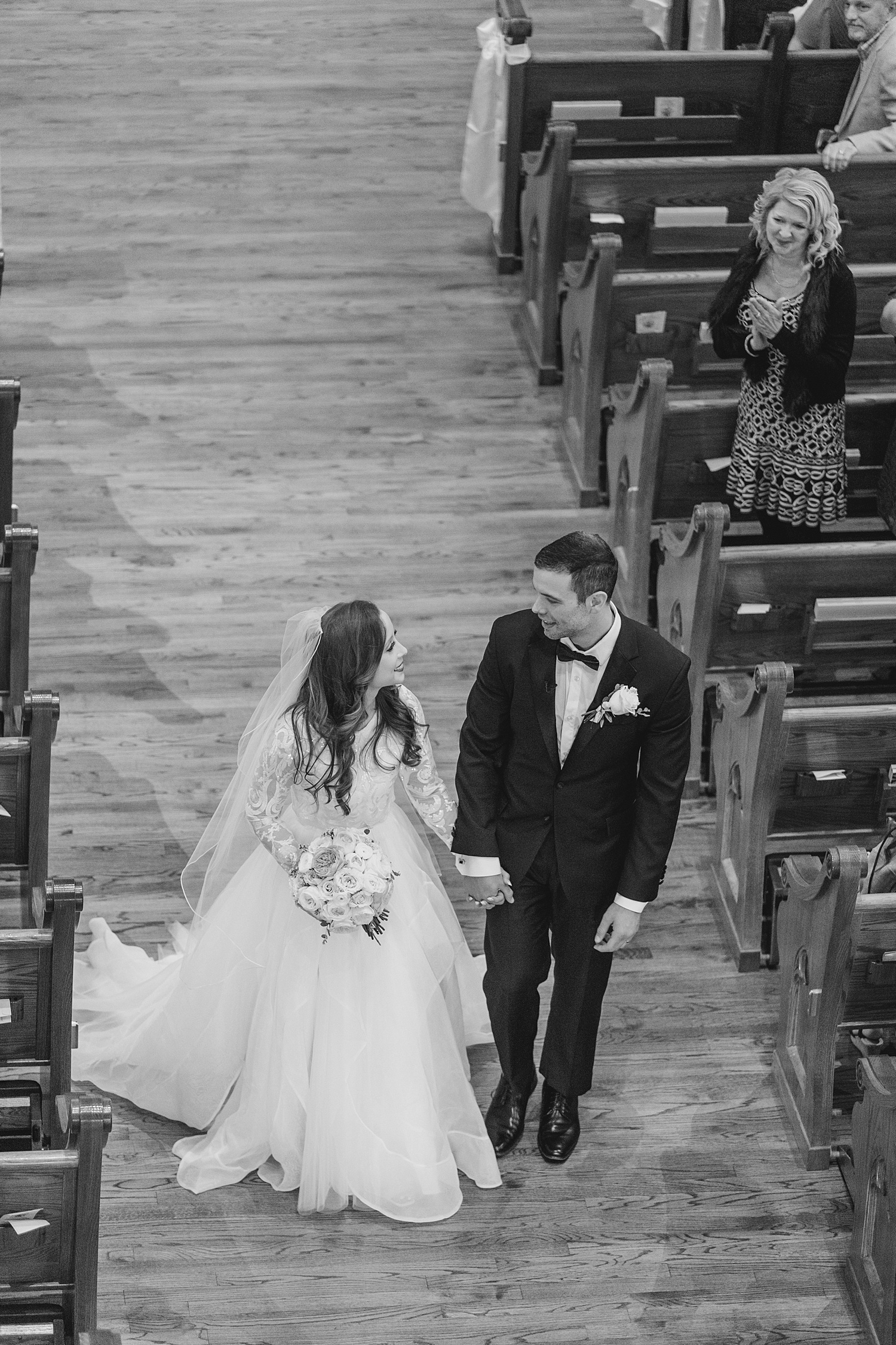 bride and groom walk down aisle together