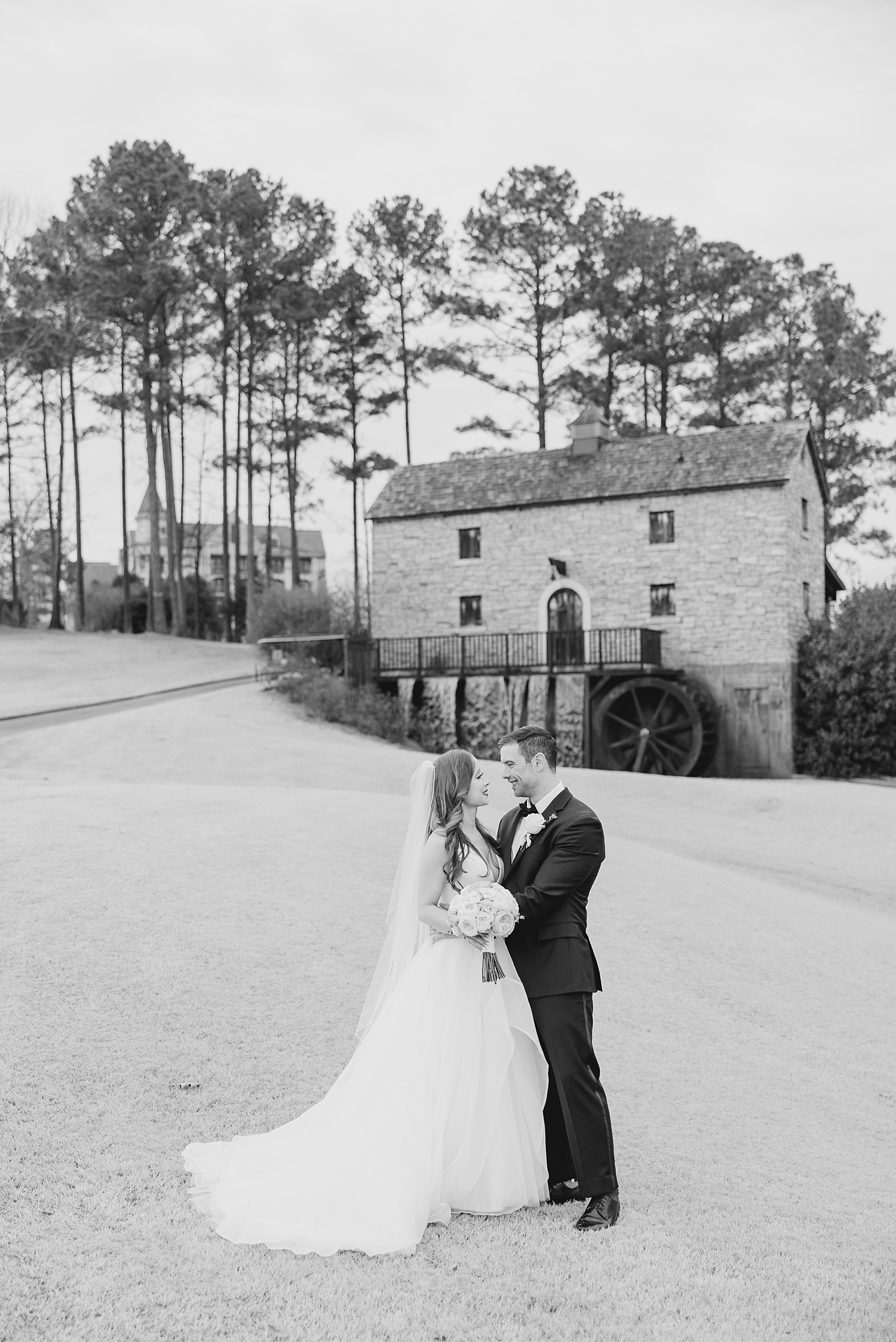 couple kiss at Ross bridge before wedding reception