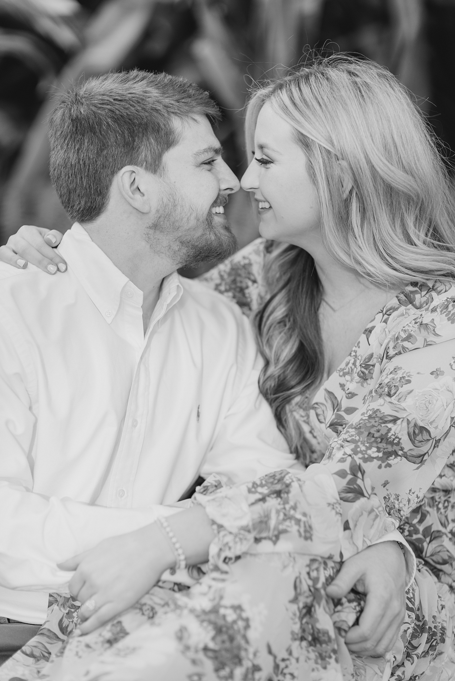 couple lean in for a kiss during engagement portraits