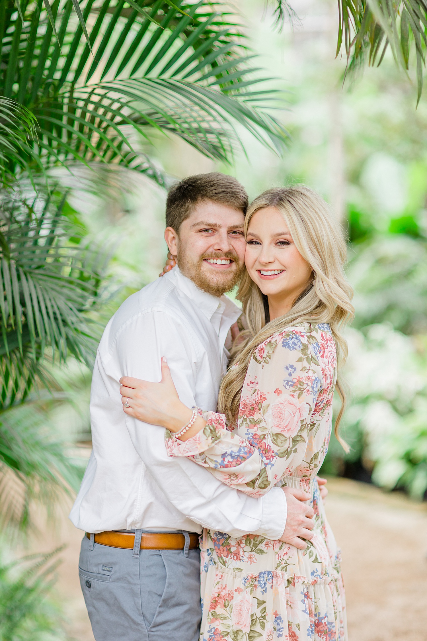 greenery surrounds couple during engagement photos